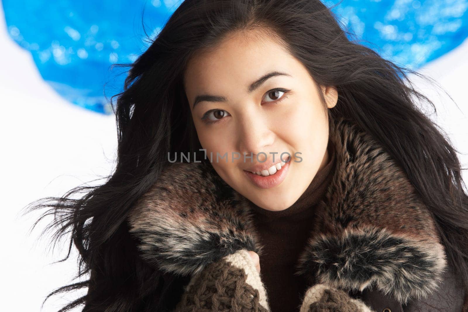 Young Woman Wearing Warm Winter Clothes In Studio