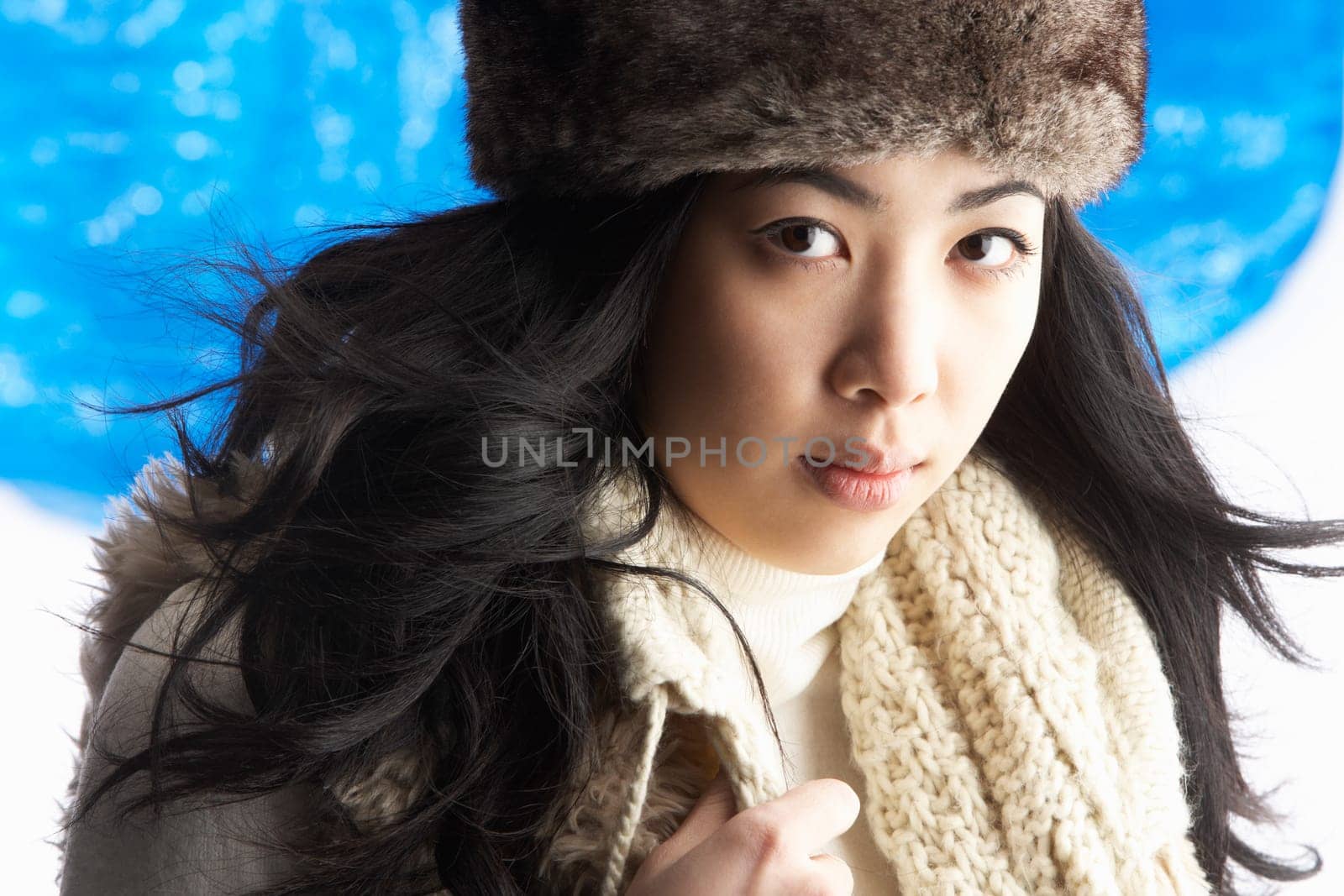 Young Woman Wearing Warm Winter Clothes And Fur Hat In Studio