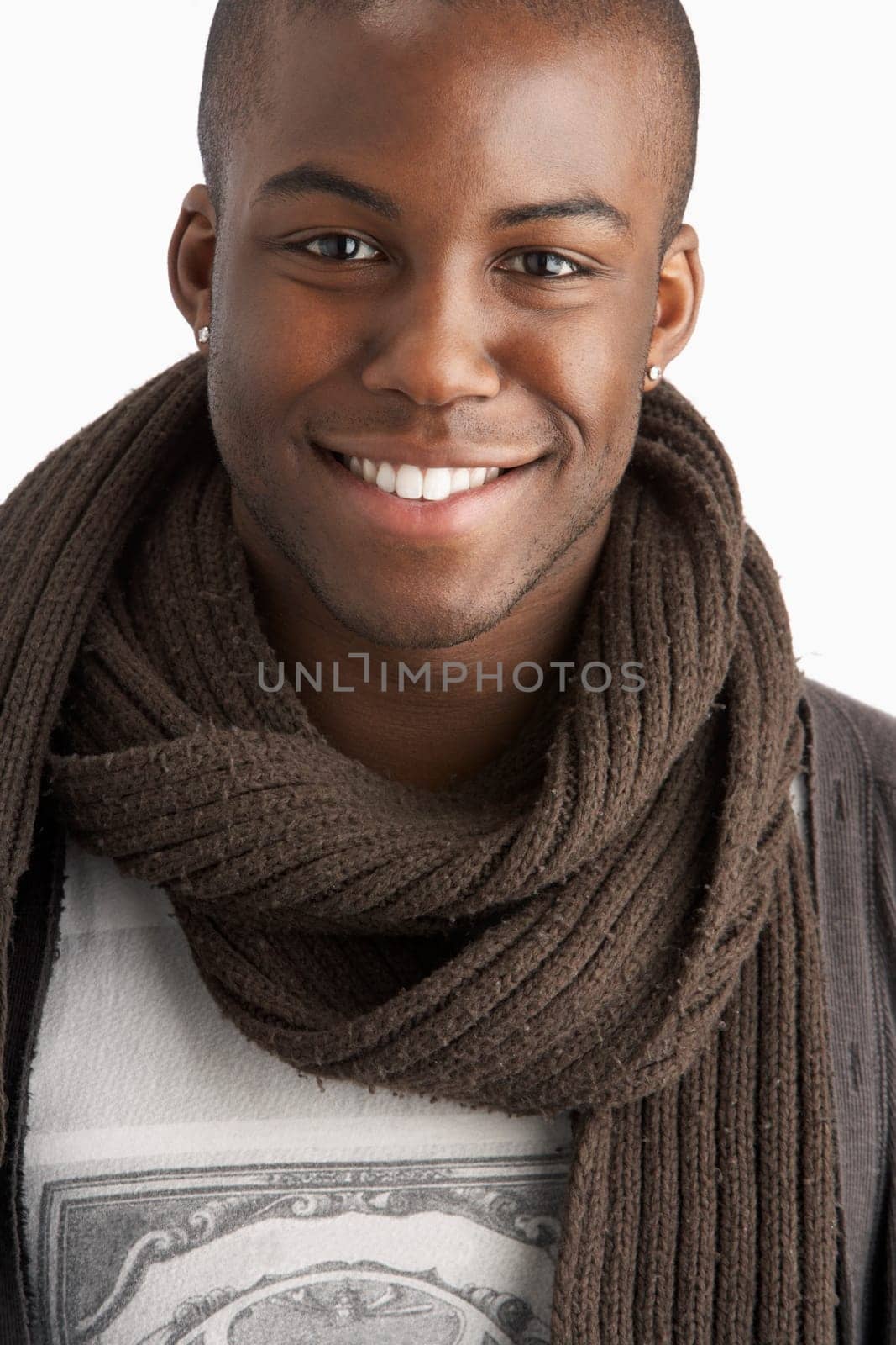 Young Man Wearing Warm Winter Clothing In Studio