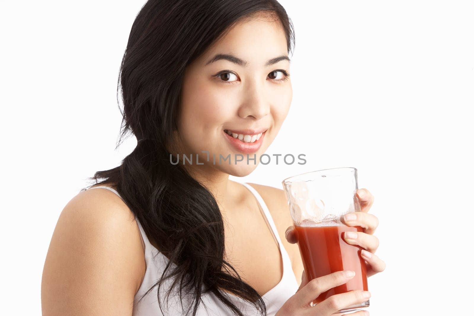 Young Woman Enjoying Healthy Drink In Studio