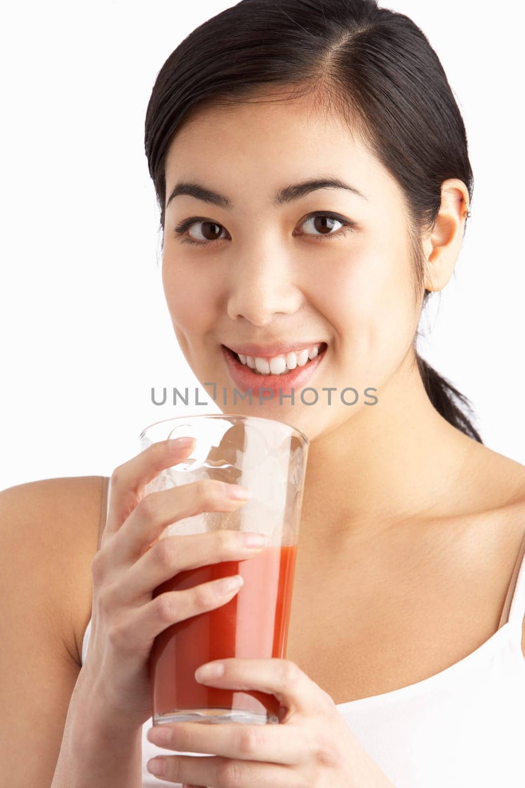 Young Woman Enjoying Healthy Drink In Studio