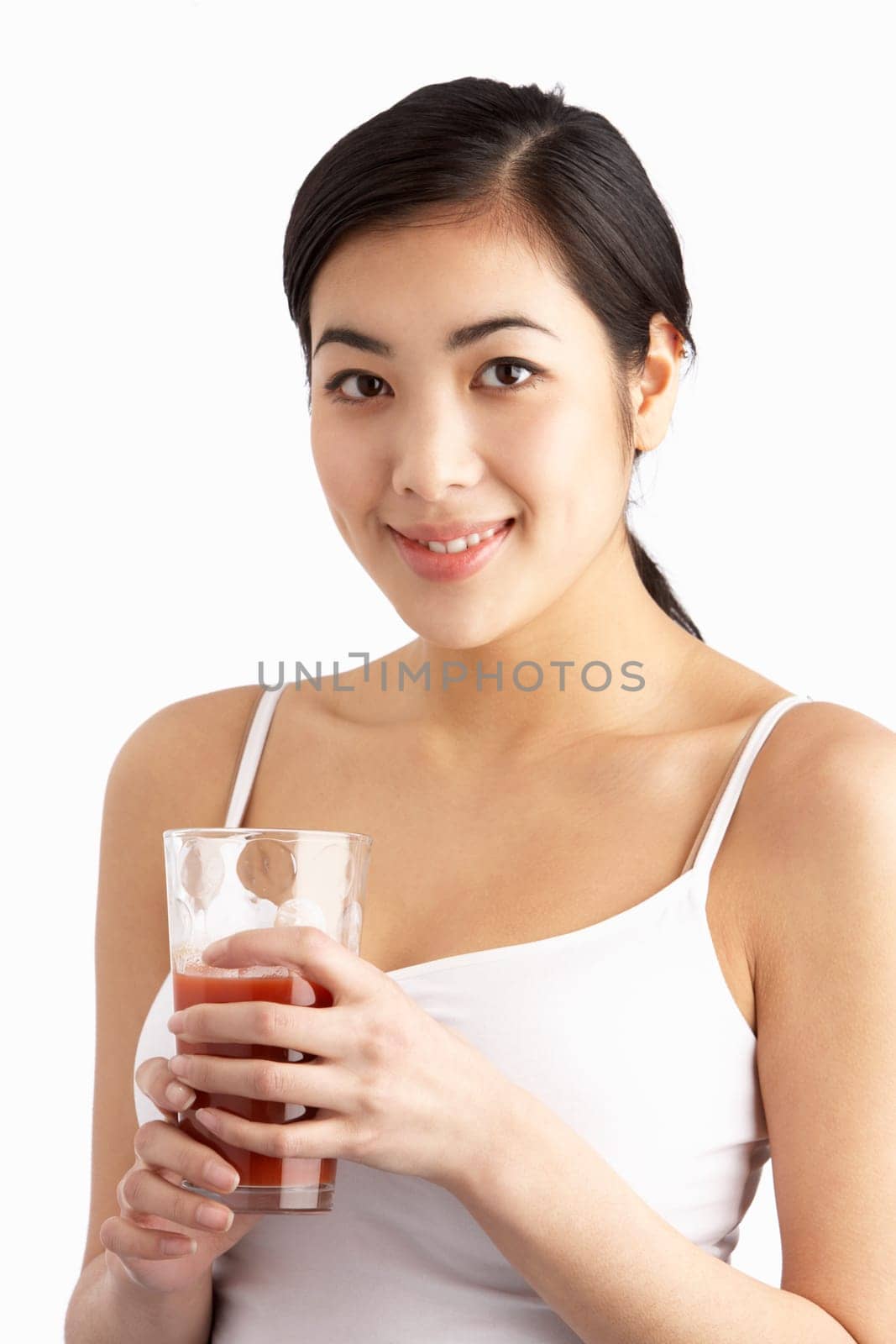 Young Woman Enjoying Healthy Drink In Studio