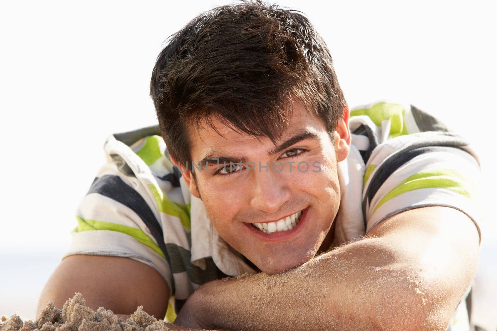 Teenage Boy Sitting On Beach