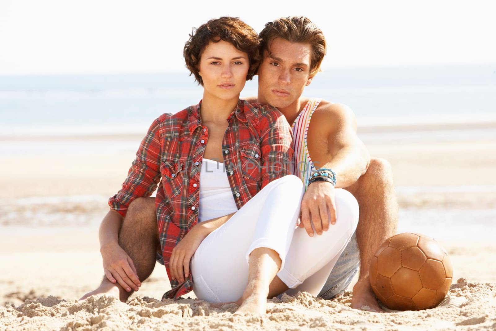 Romantic Young Couple Relaxing On Beach