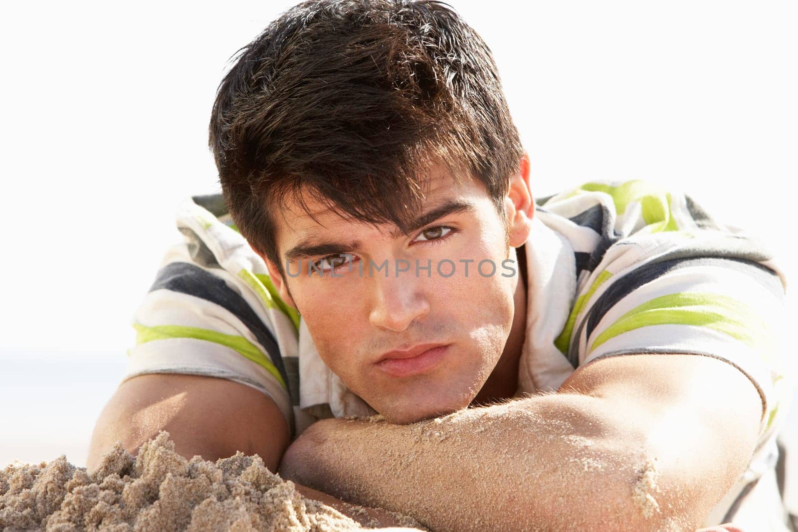 Teenage Boy Sitting On Beach
