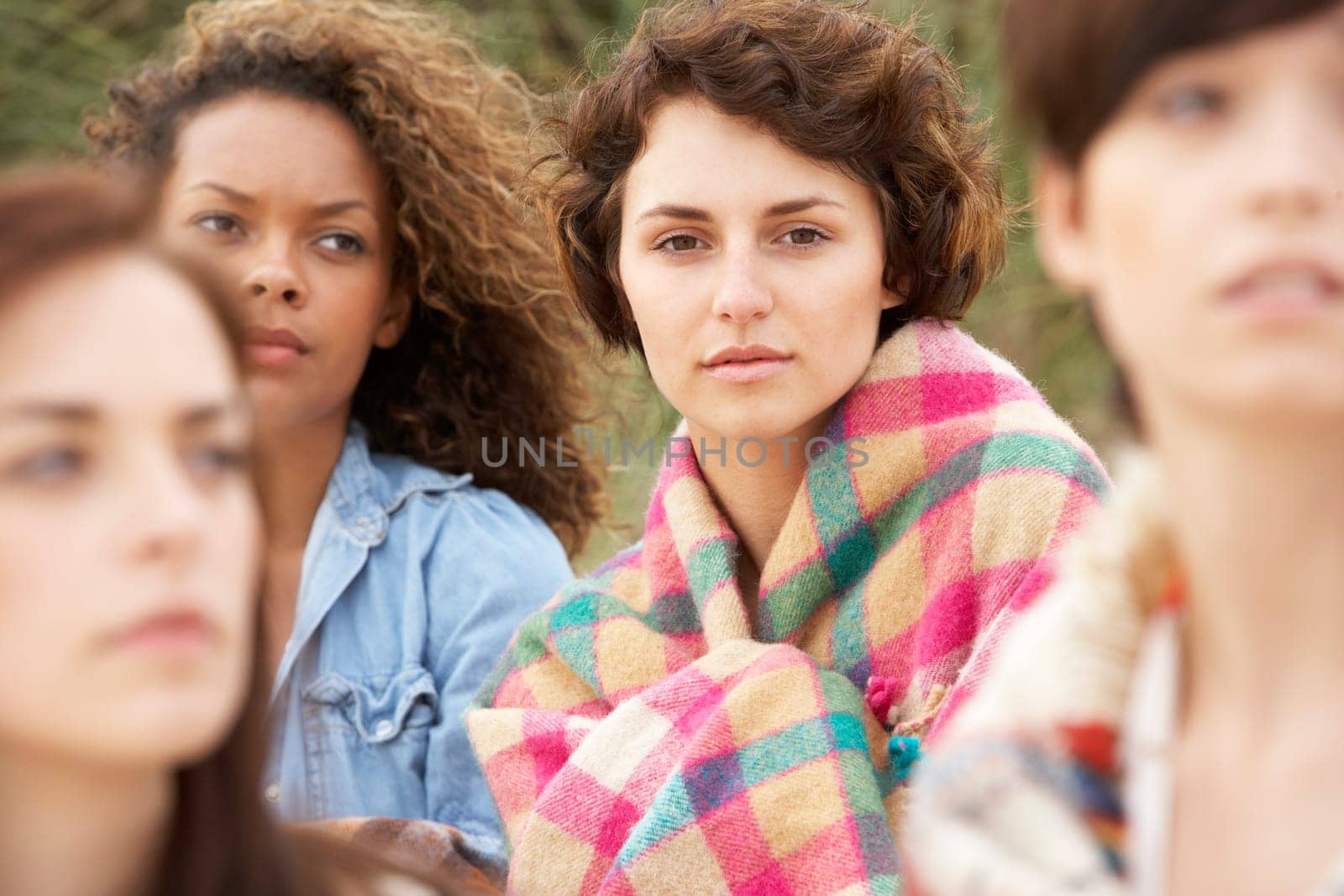 Close Up Of Group Of Girls Sitting On Beach Together
