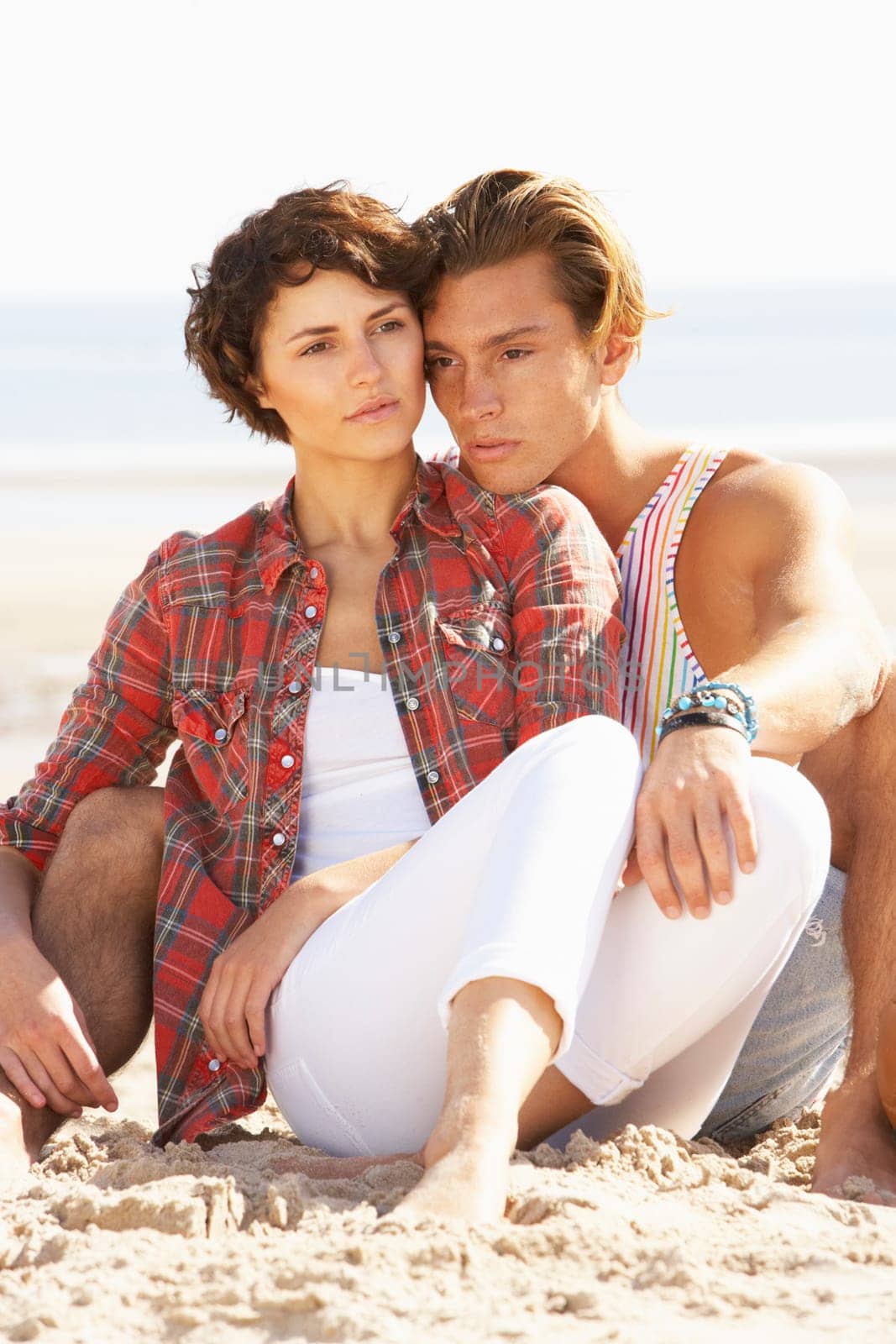 Romantic Young Couple Relaxing On Beach