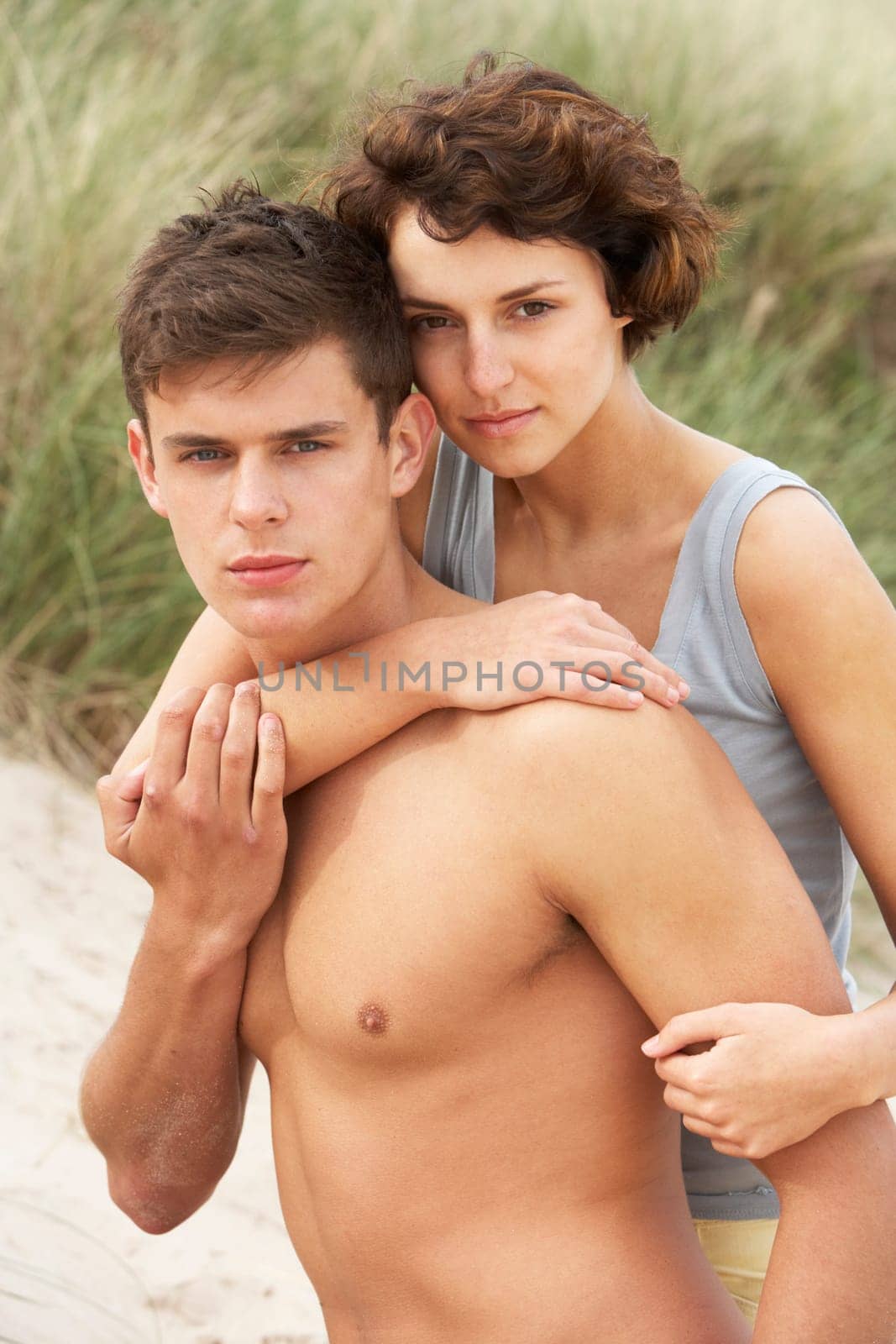 Romantic Young Couple Embracing On Beach