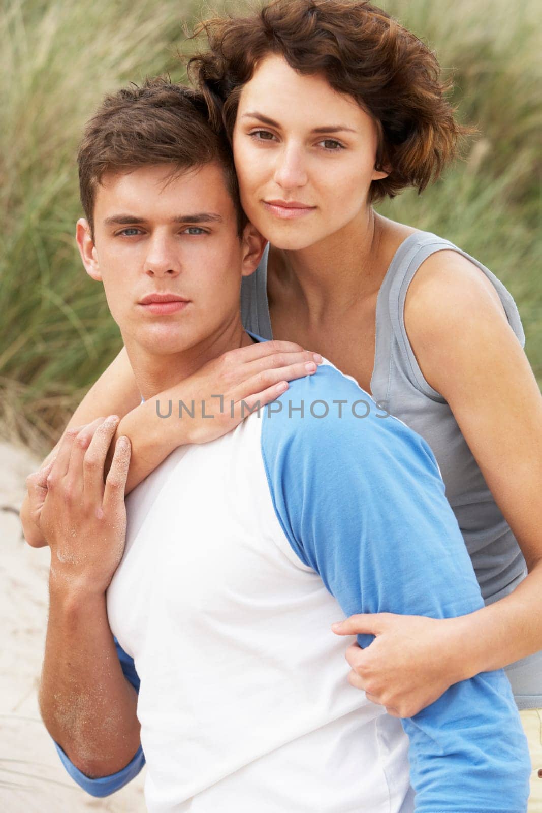 Romantic Young Couple Embracing On Beach