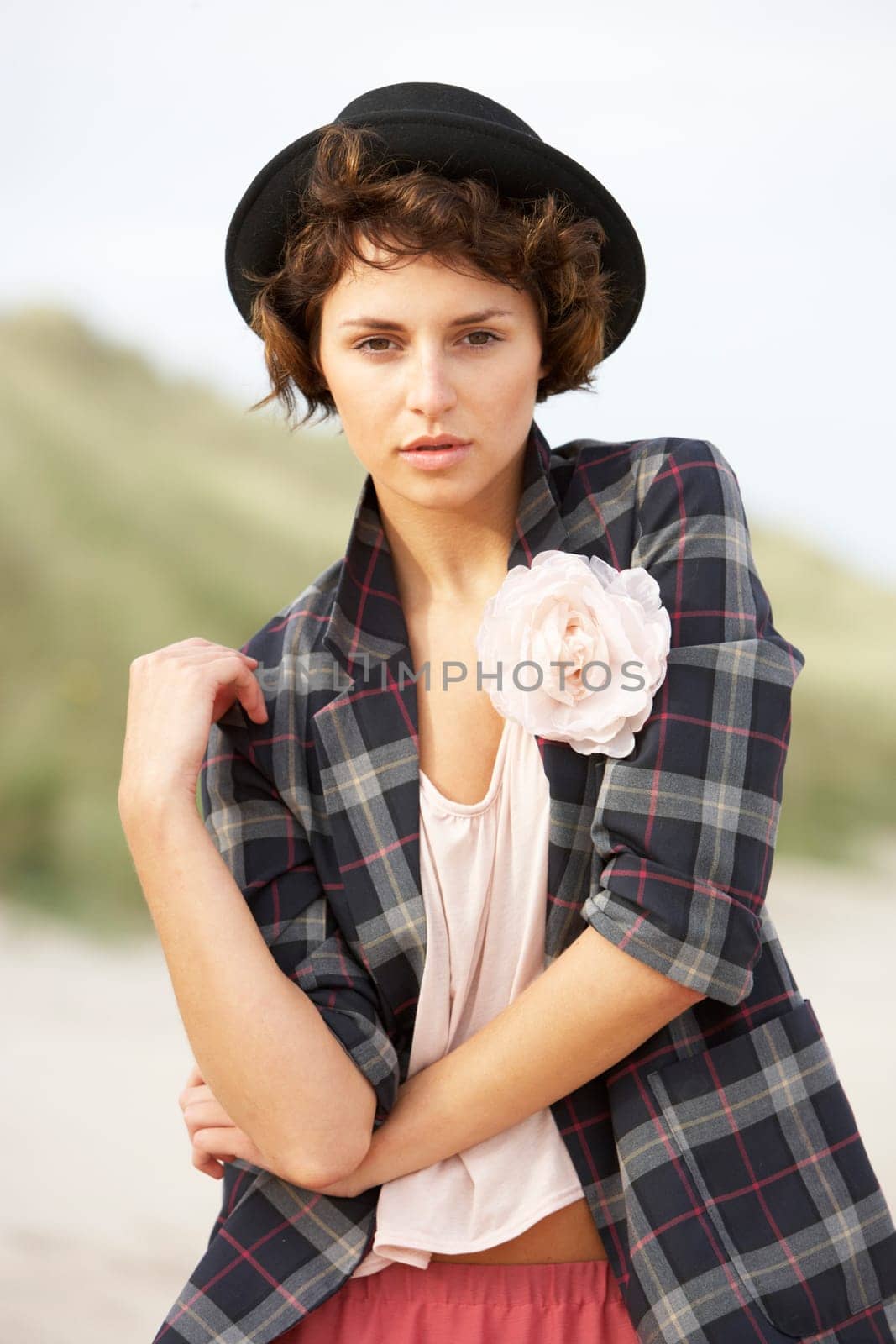 Fashionably Dressed Attractive Young Woman Standing Amongst Sand Dunes