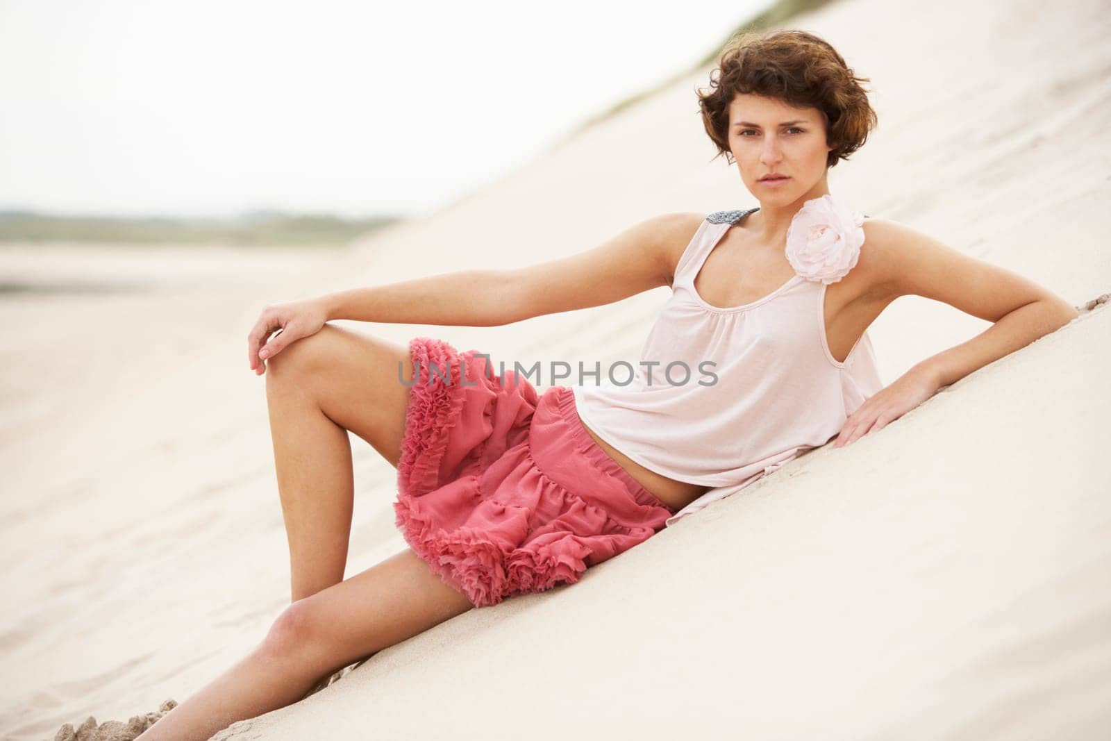 Fashionably Dressed Attractive Young Woman Standing Amongst Sand Dunes