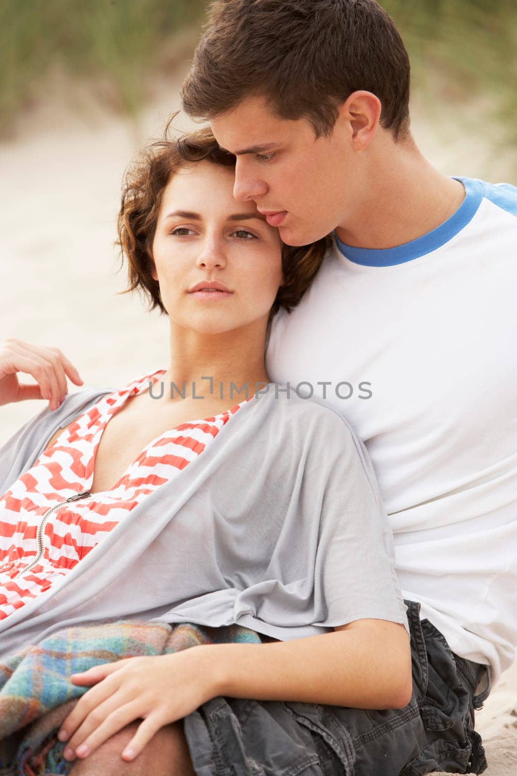 Romantic Young Couple Embracing On Beach
