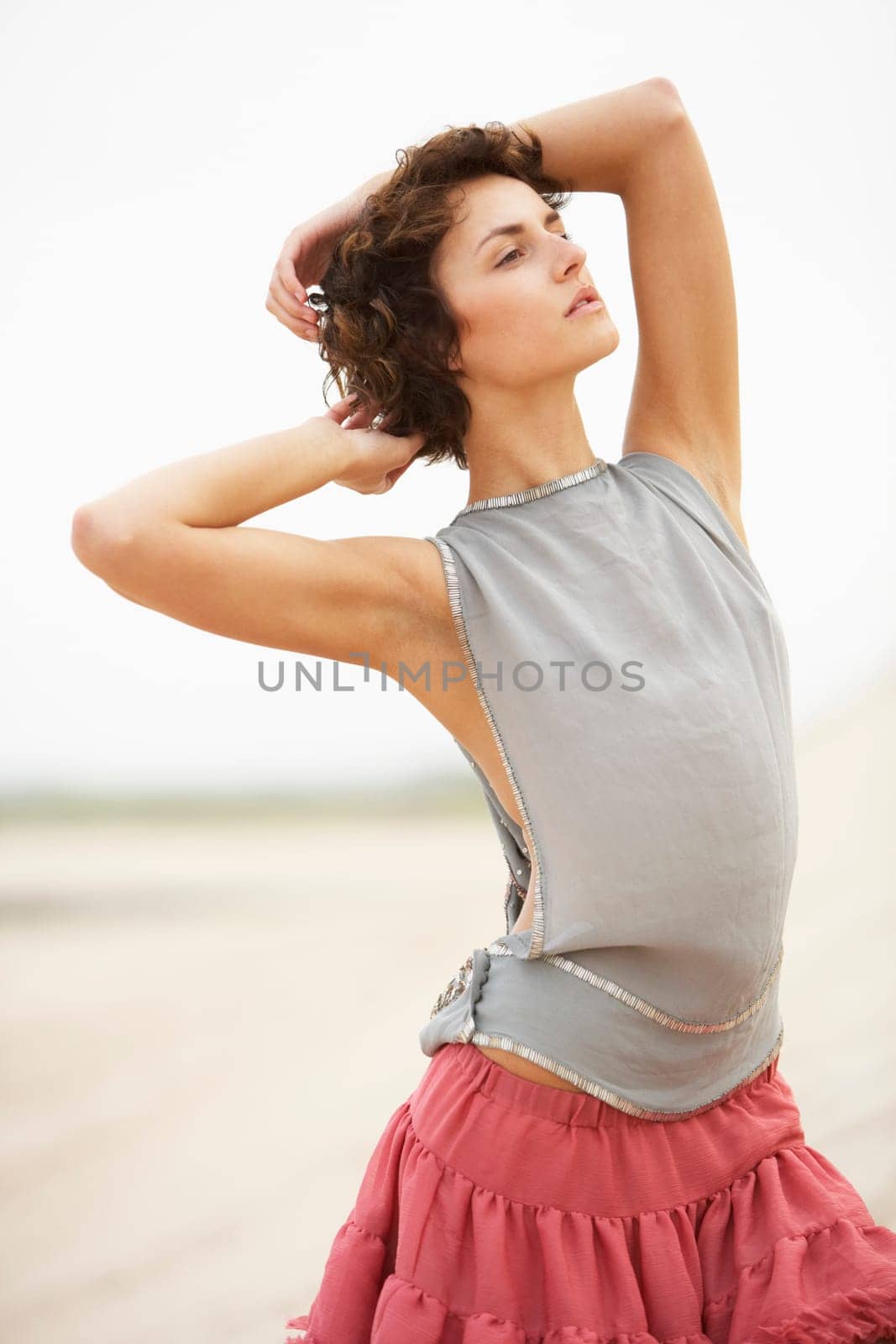 Attractive Young Woman Wearing Revealing Clothing Standing Amongst Sand Dunes