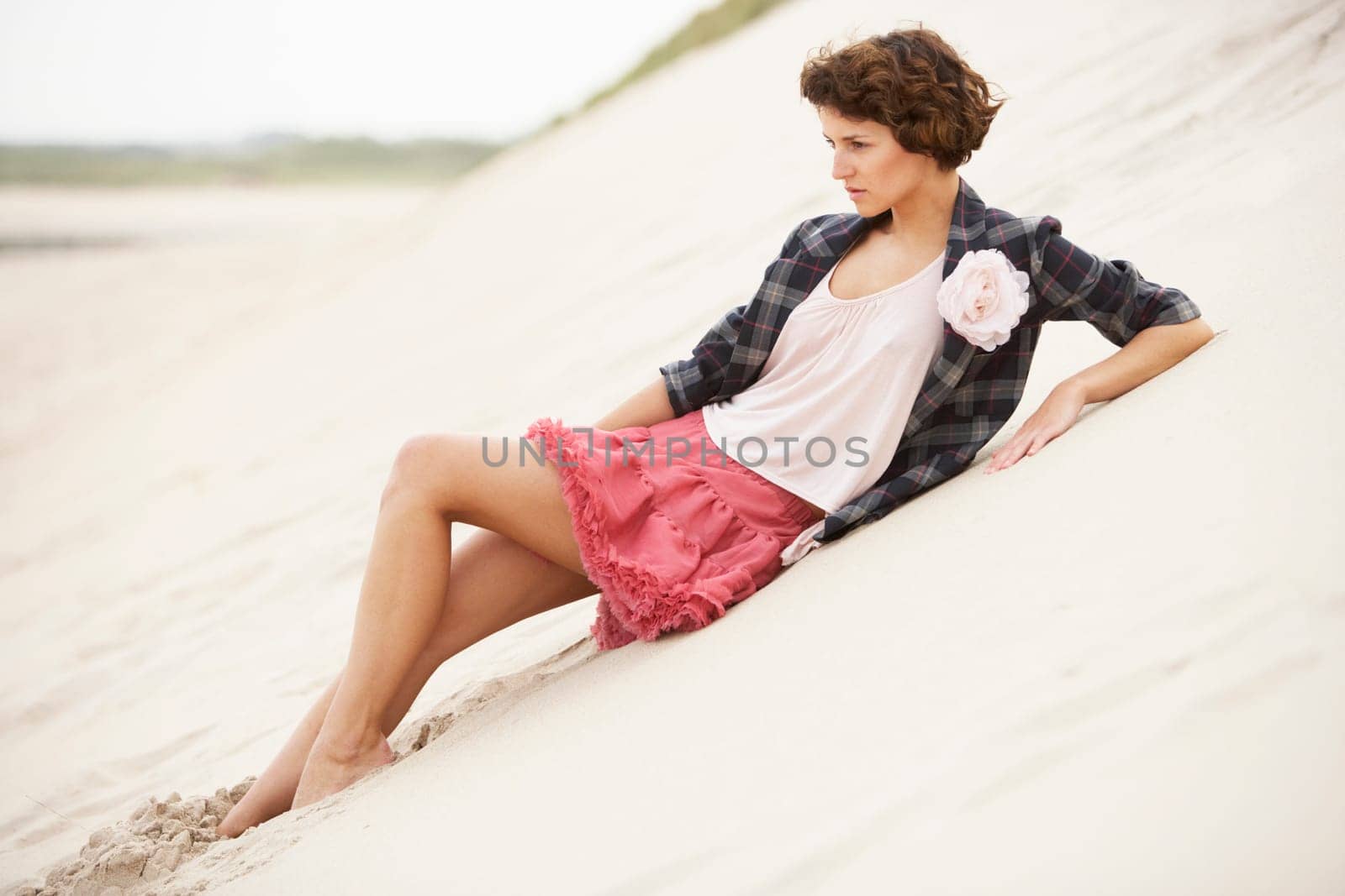 Fashionably Dressed Attractive Young Woman Standing Amongst Sand Dunes