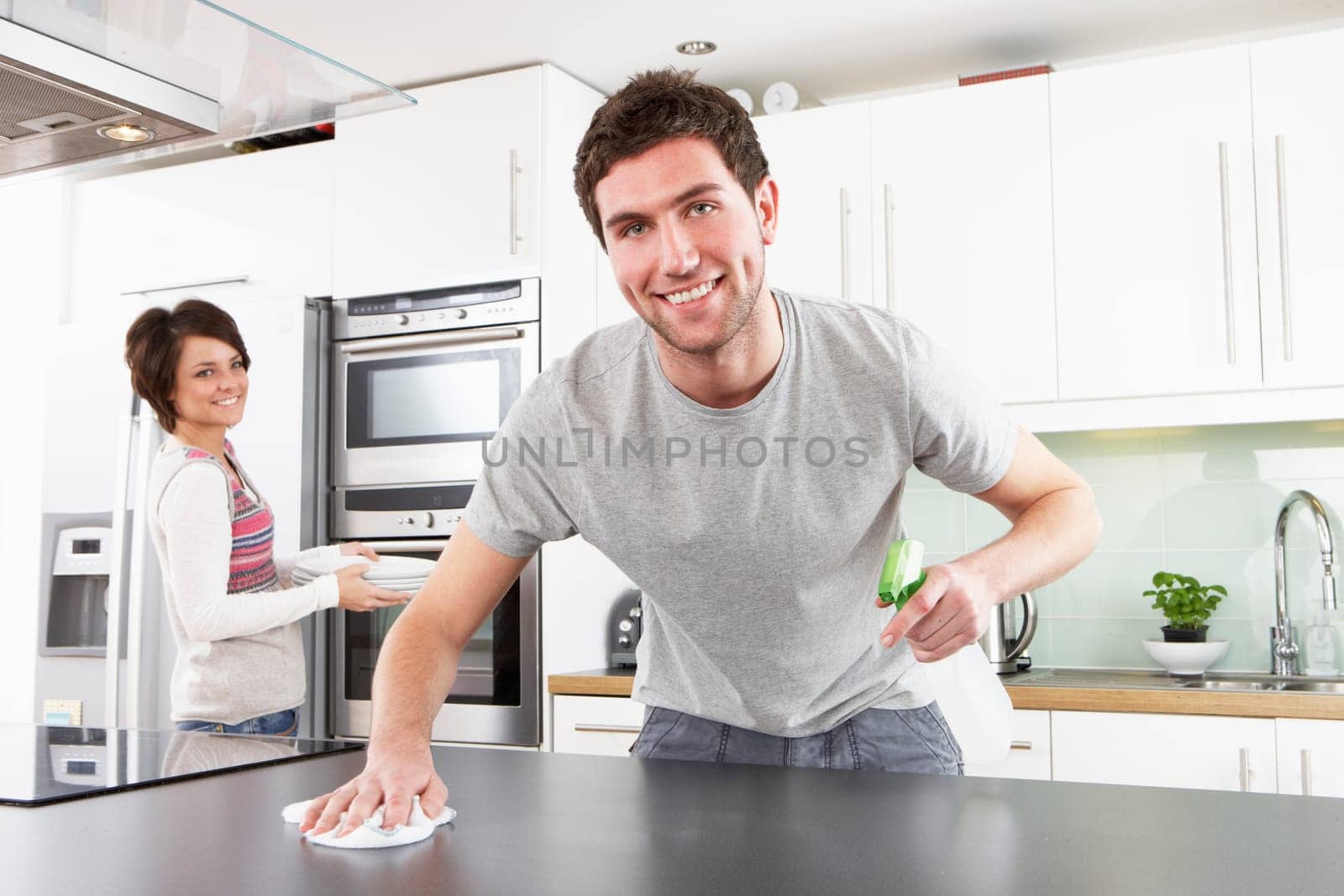 Young Couple Cleaning Cleaning Modern Kitchen