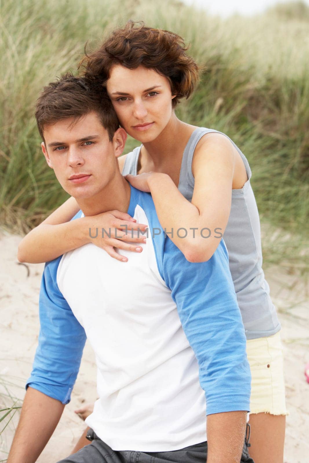 Romantic Young Couple Embracing On Beach