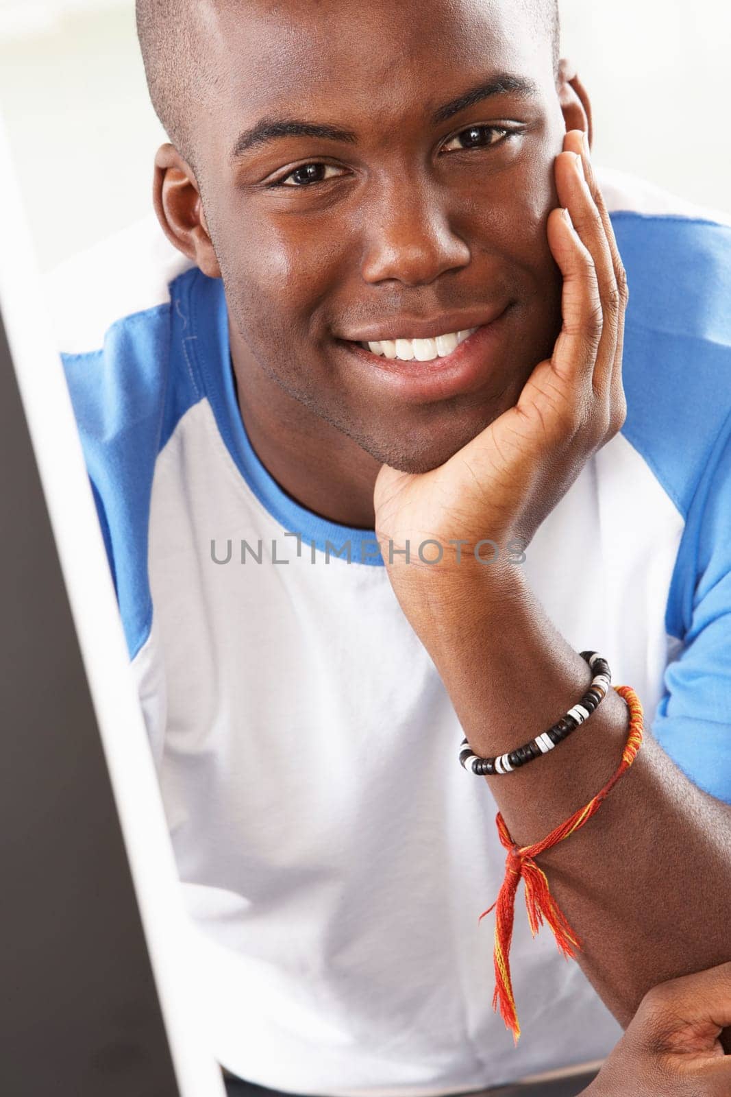 Young Man Using Computer In Modern Kitchen