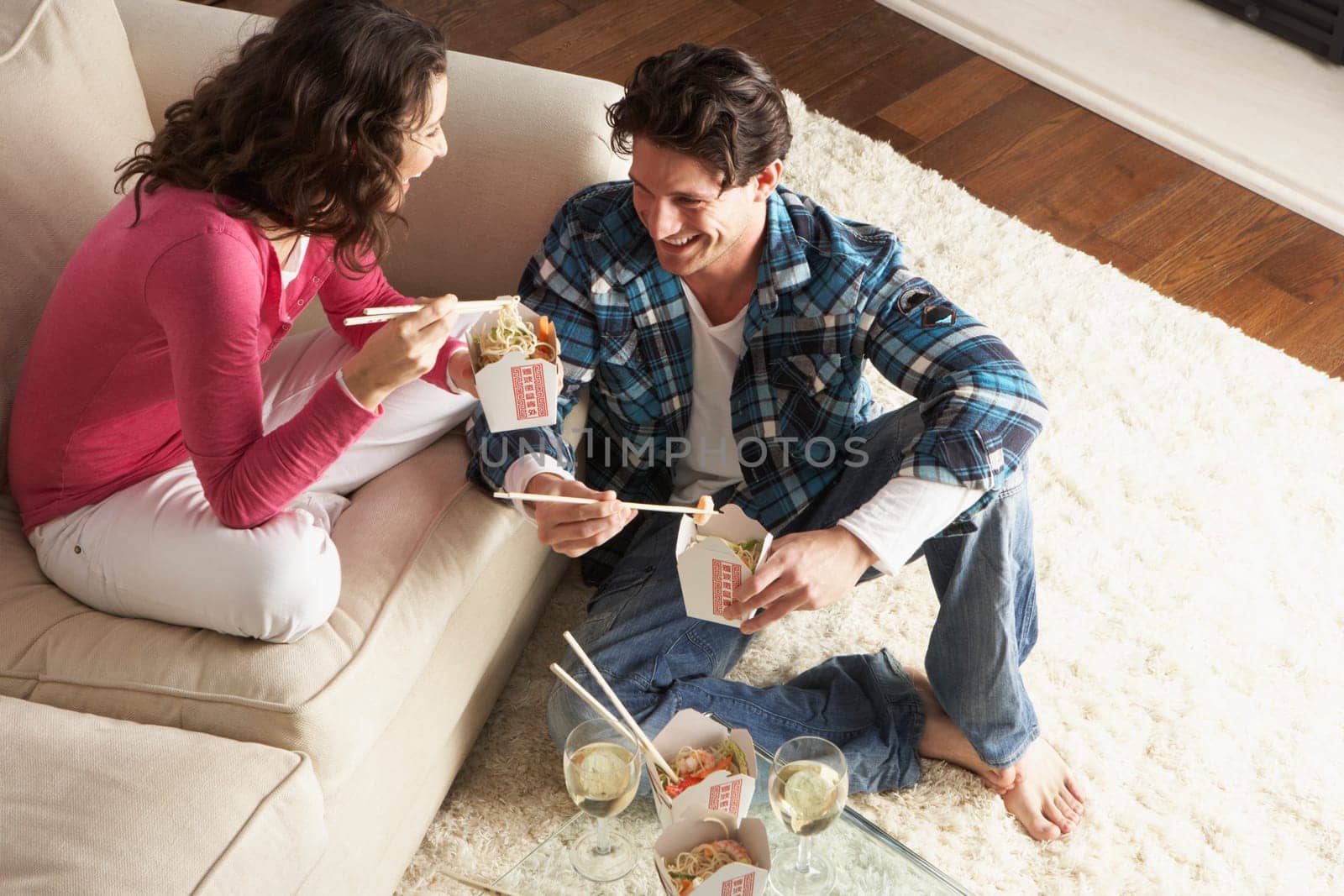 Couple Enjoying Chinese Takeaway Meal At Home
