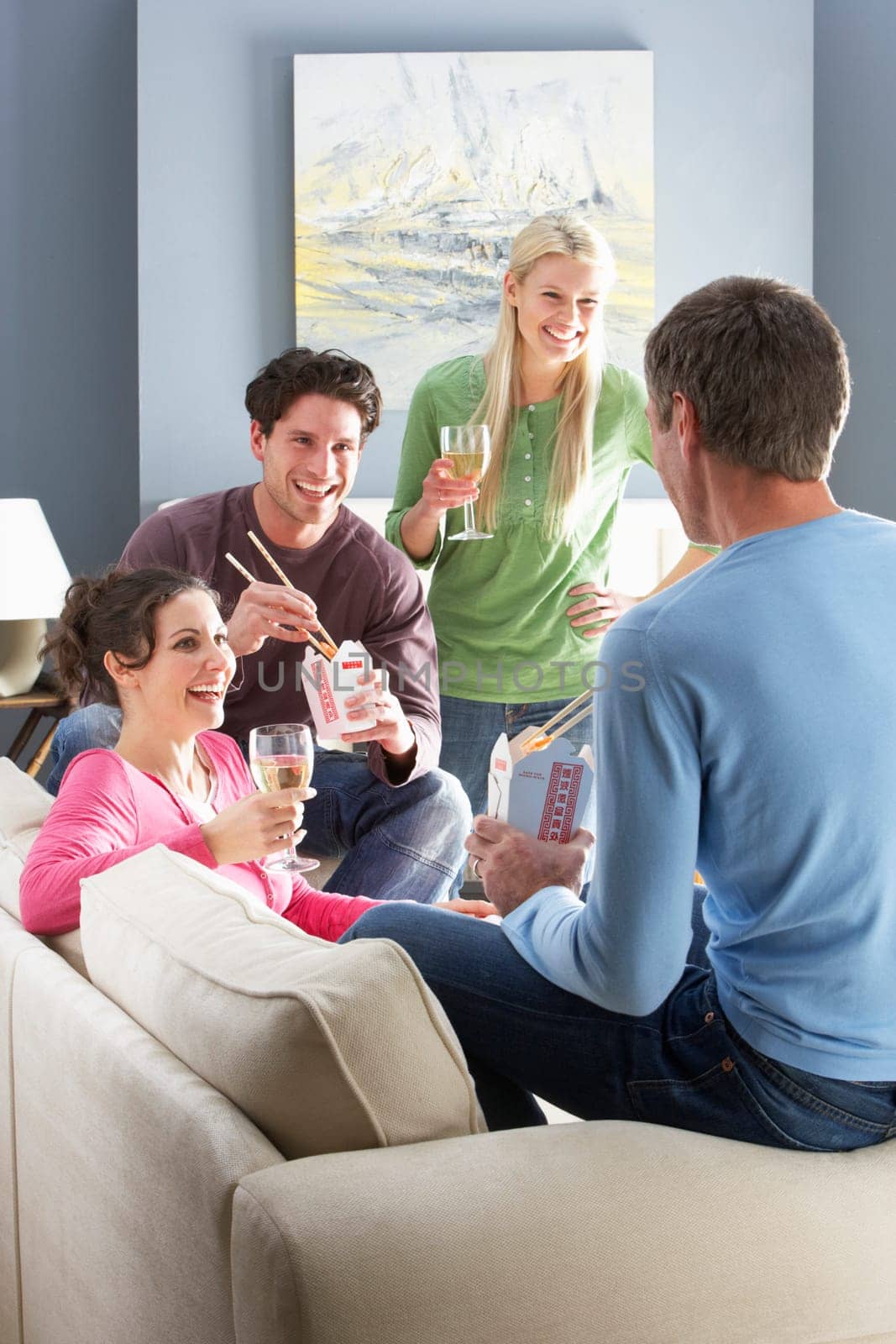 Group Of Friends Enjoying Chinese Takeaway Meal At Home