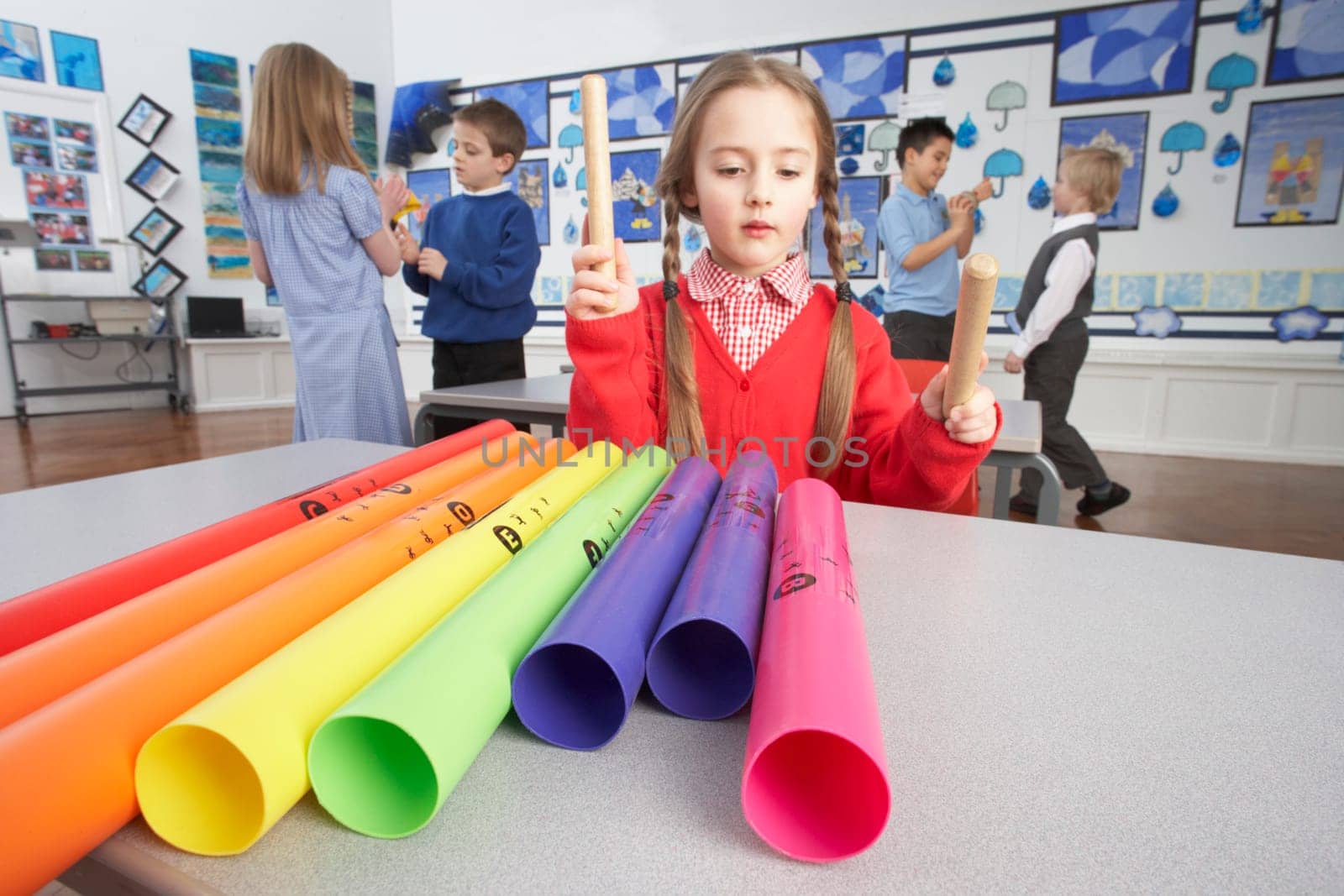 Group Of Primary Schoolchildren Having Music Lesson In Classroom