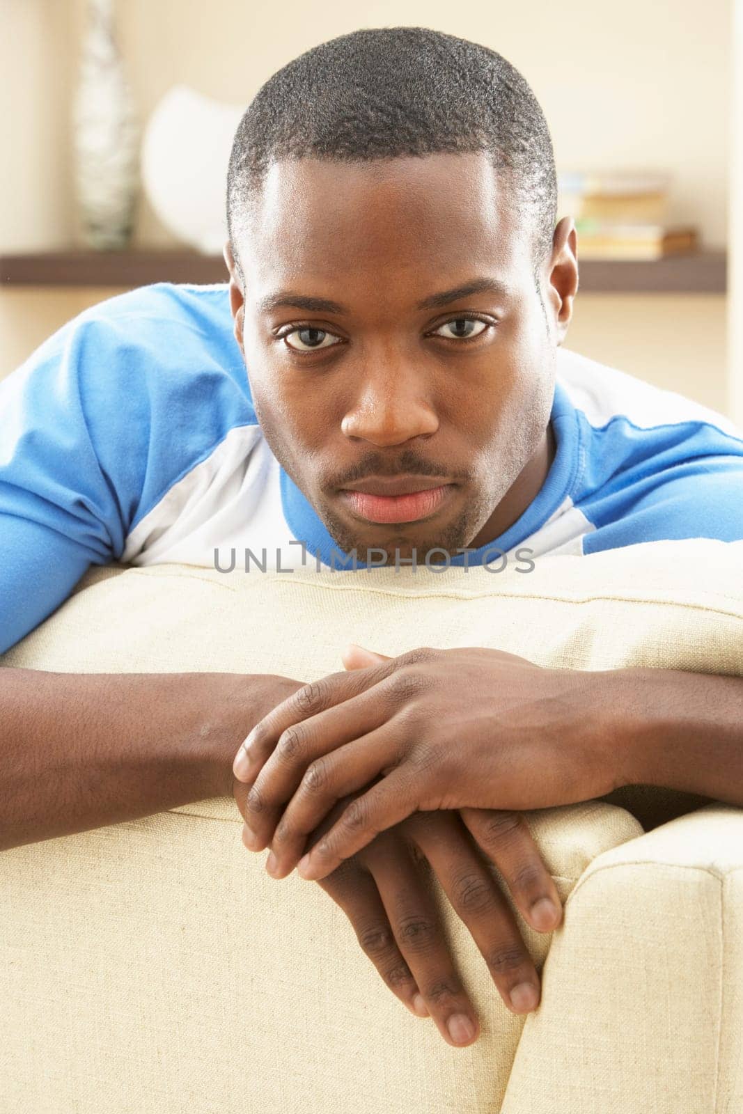 Man Relaxing On Sofa At Home