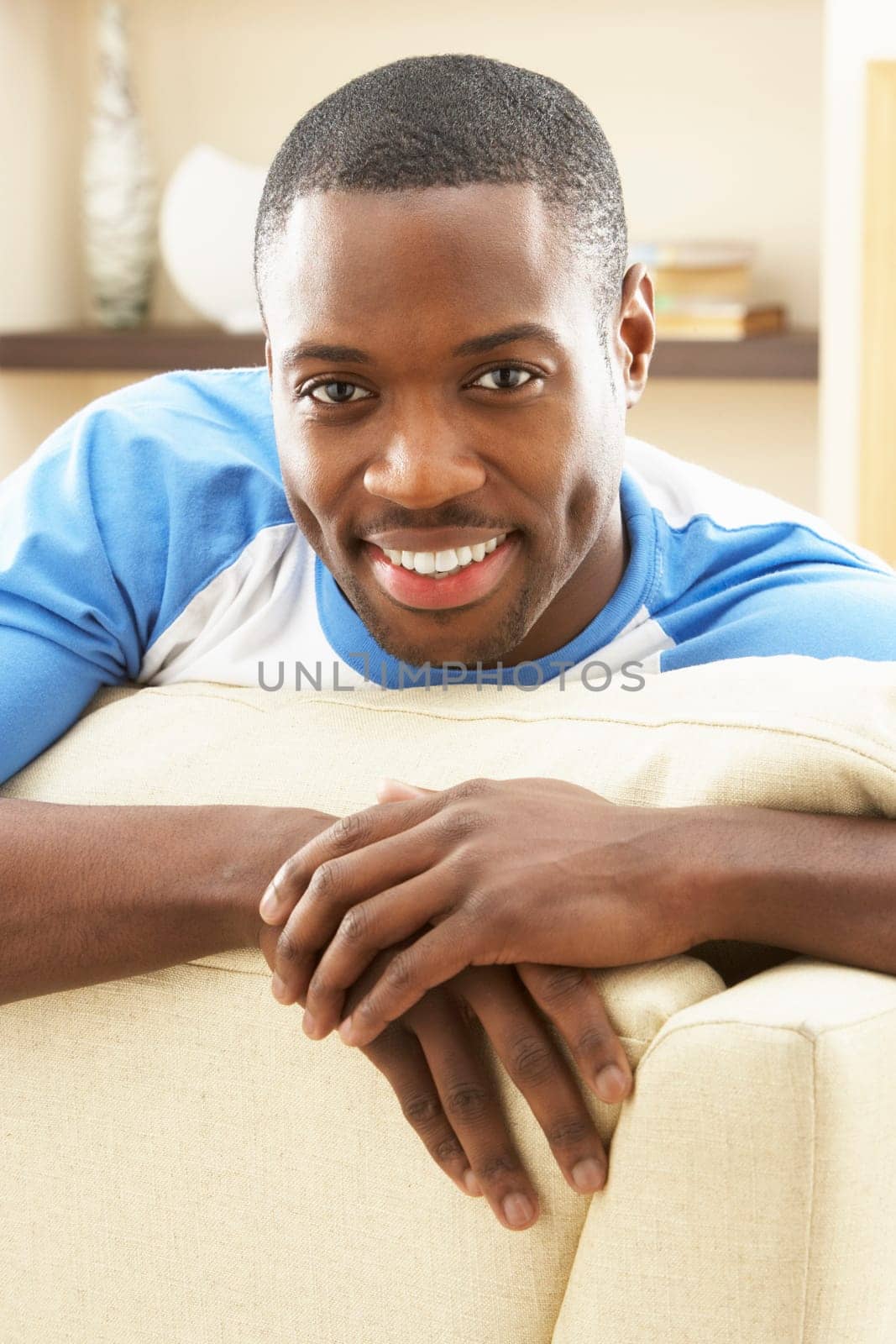 Man Relaxing On Sofa At Home