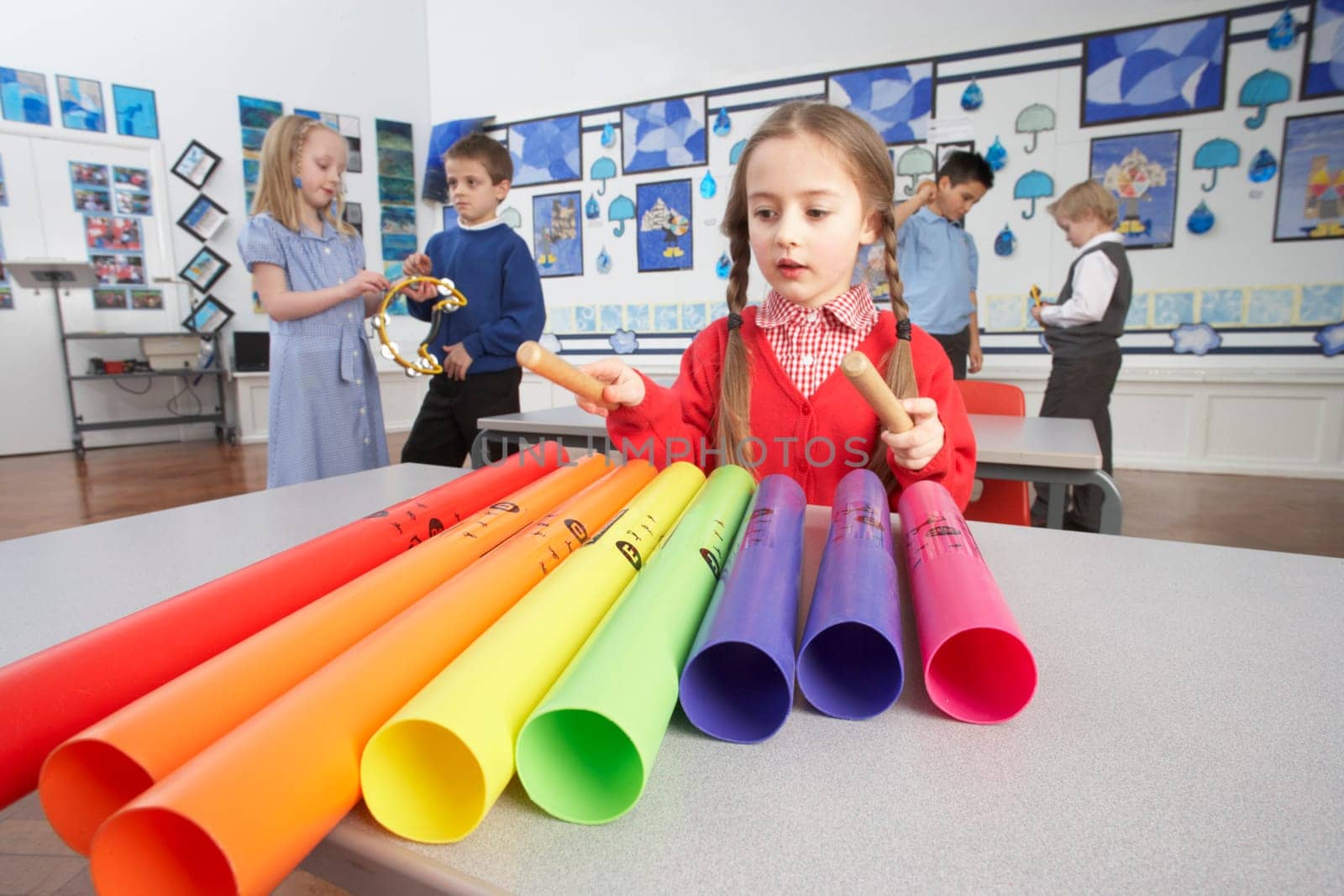 Group Of Primary Schoolchildren Having Music Lesson In Classroom