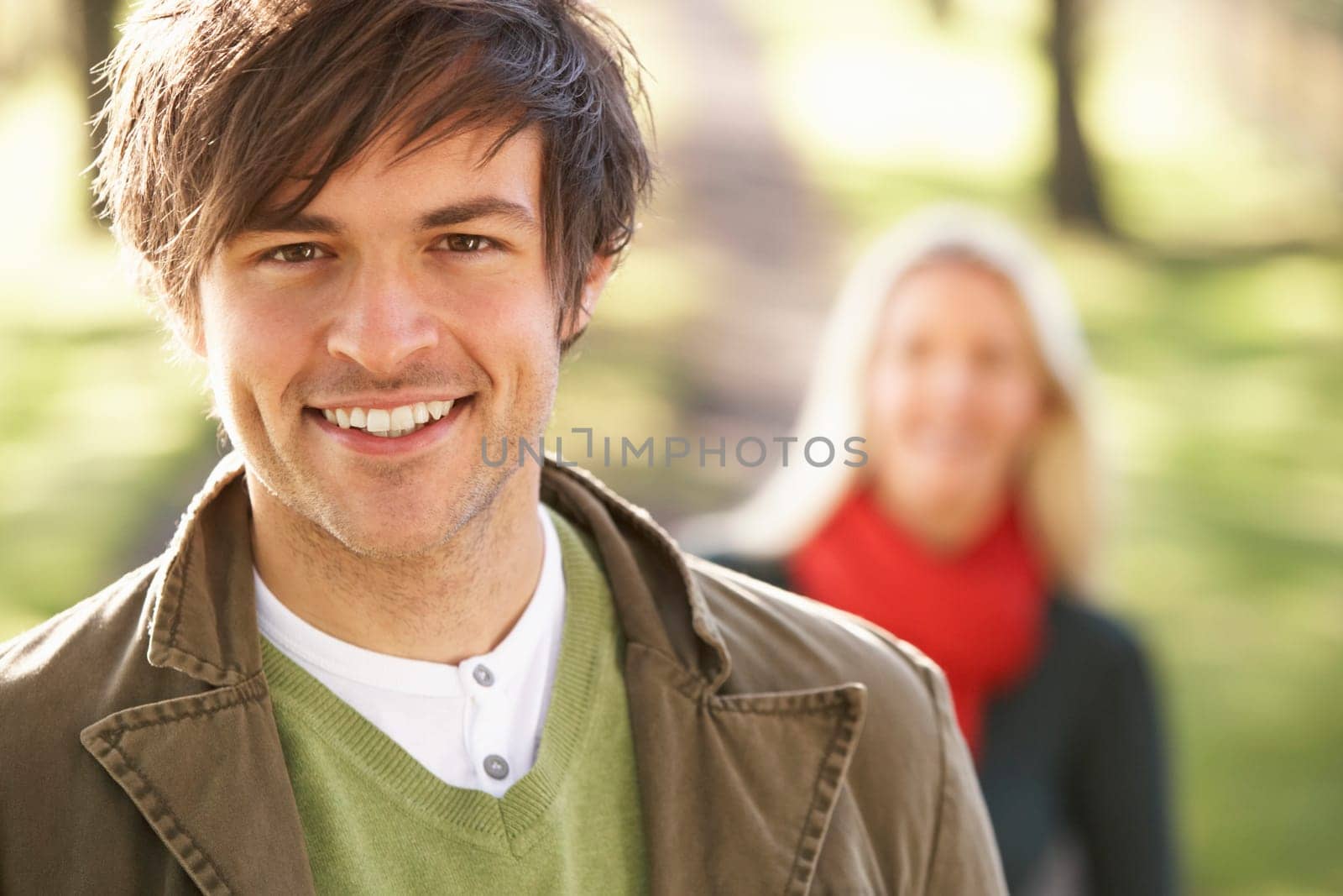 Portrait Of Romantic Young Couple In Autumn Park