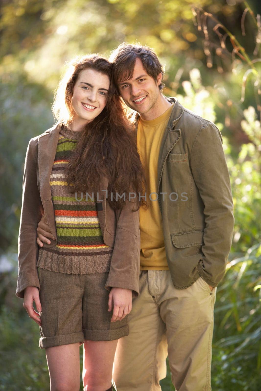 Portrait Of Romantic Young Couple In Autumn Landscape