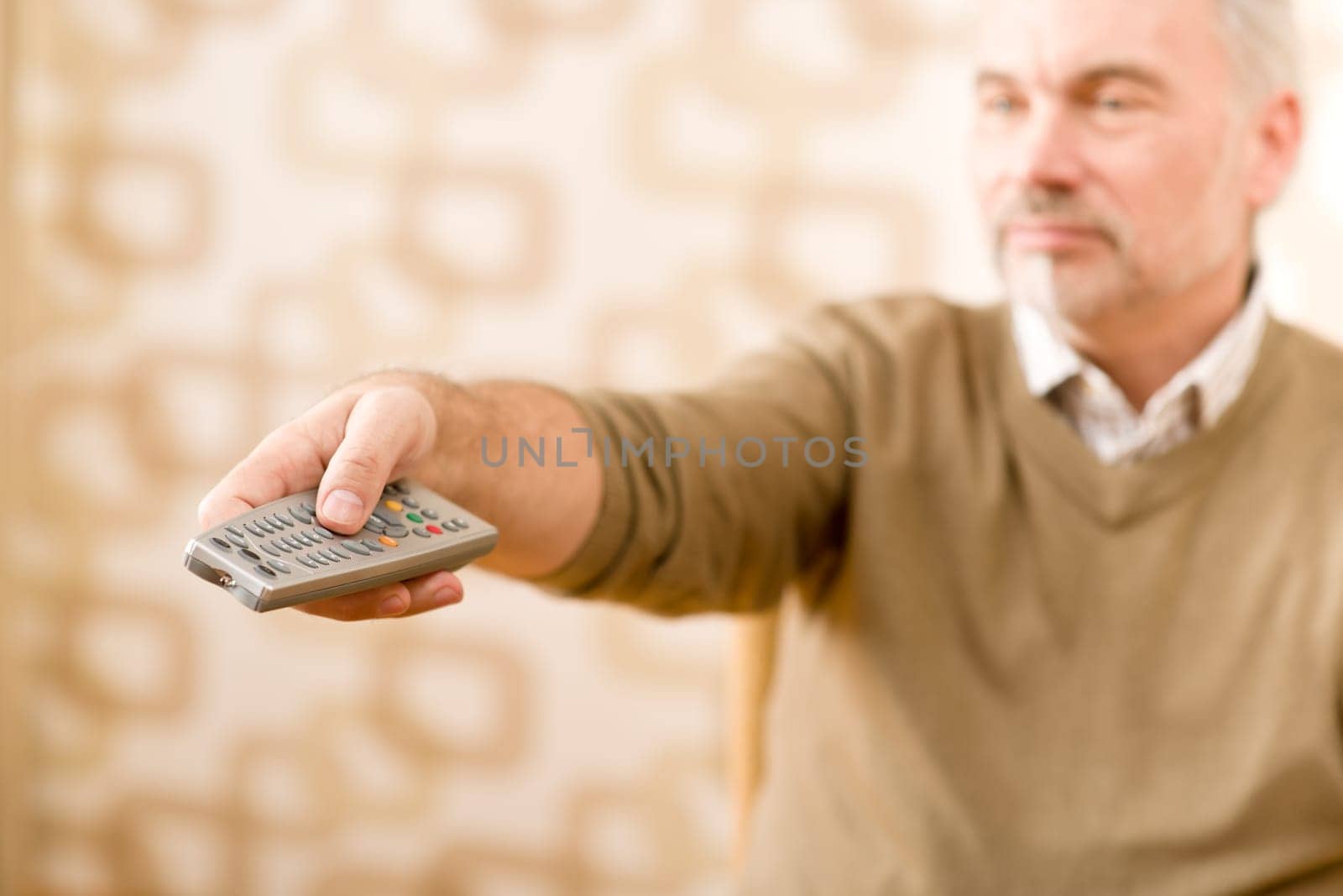 Senior mature man with remote control