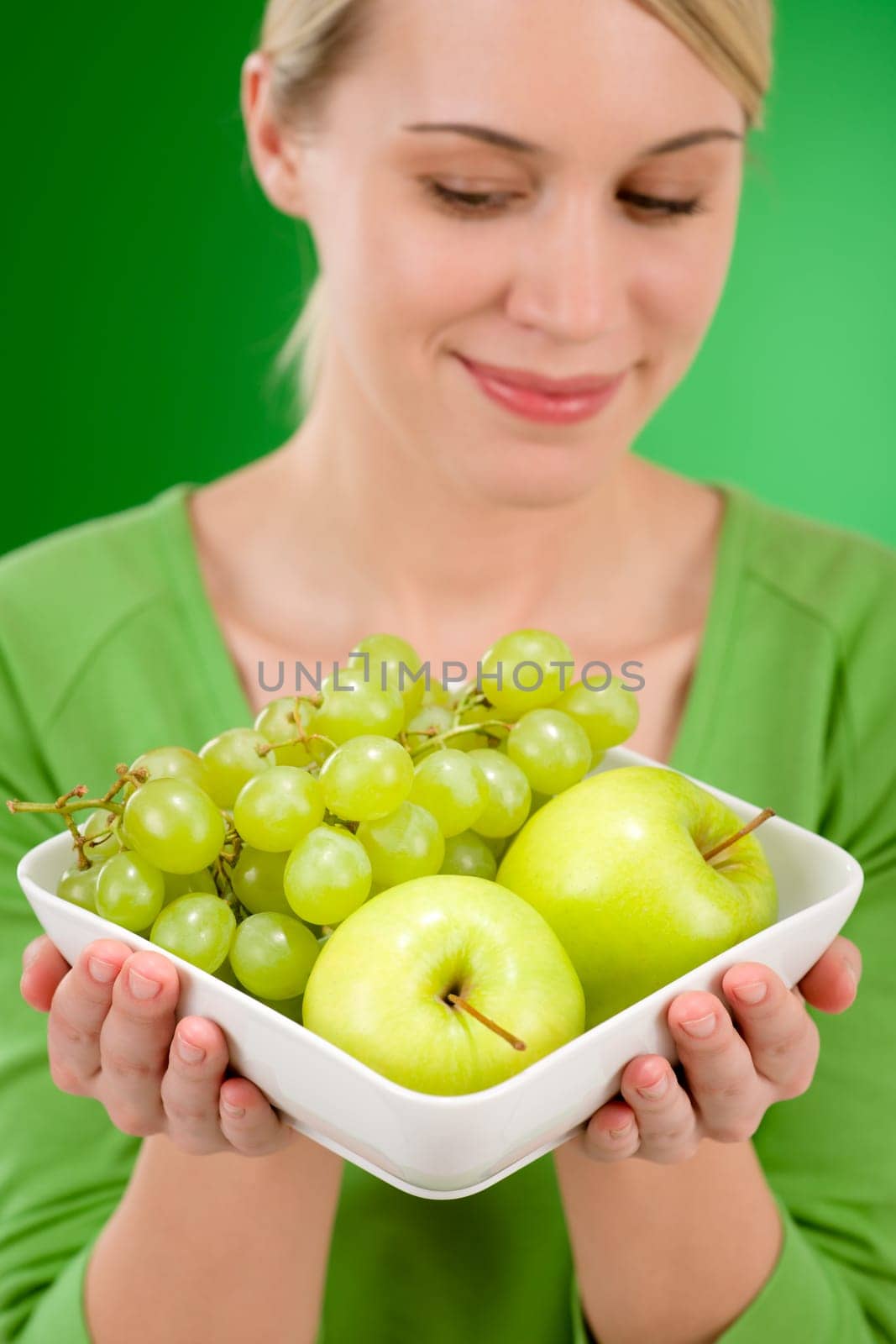 Healthy lifestyle - woman holding bowl with fruit