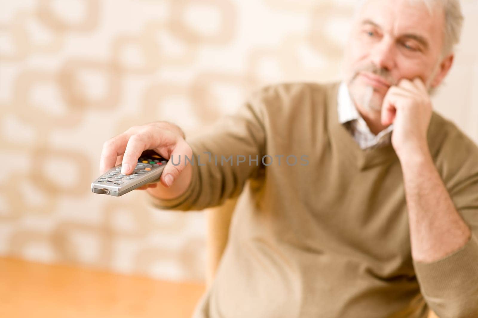 Senior mature man with remote control