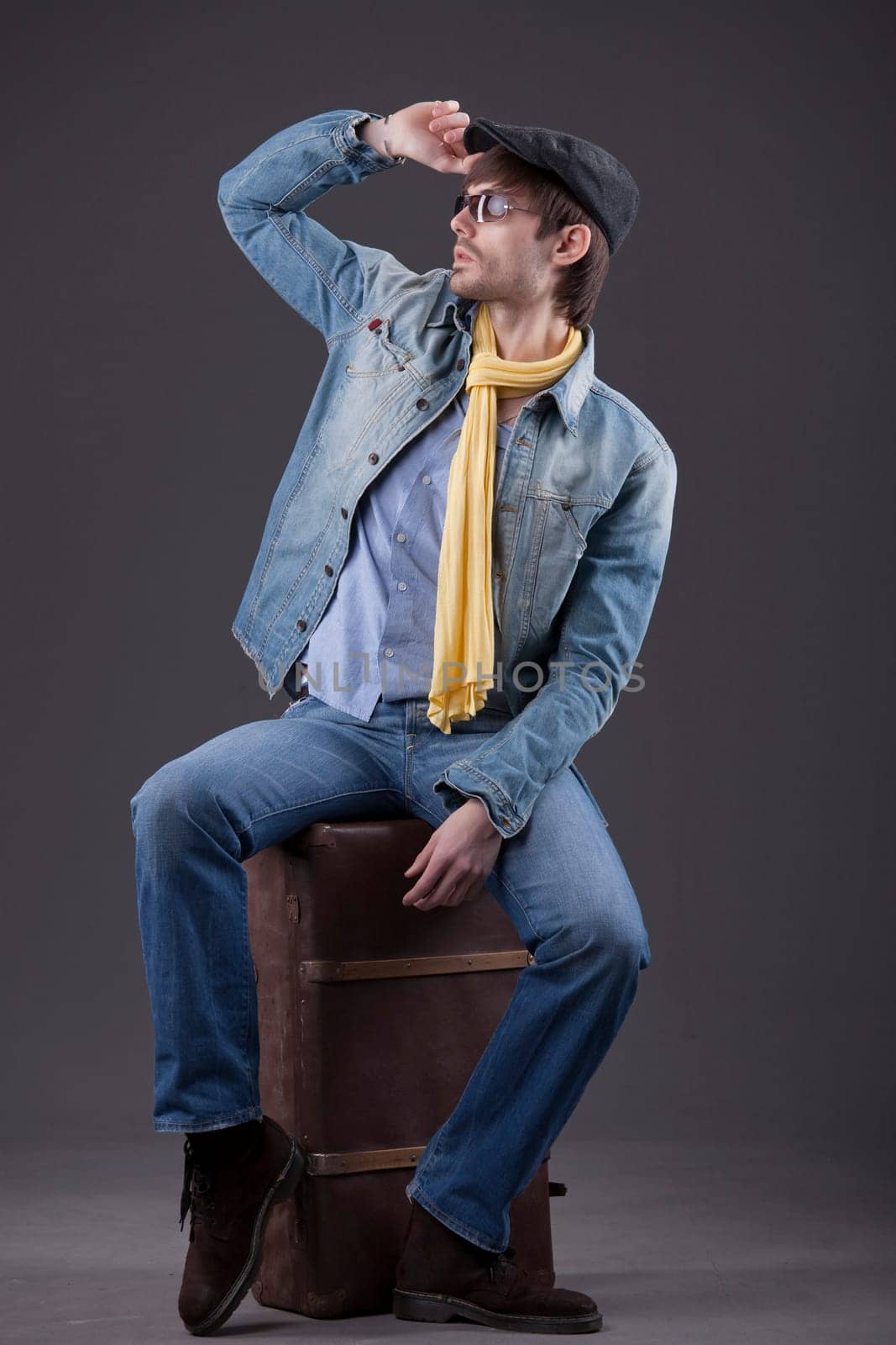 man sitting on suitcase