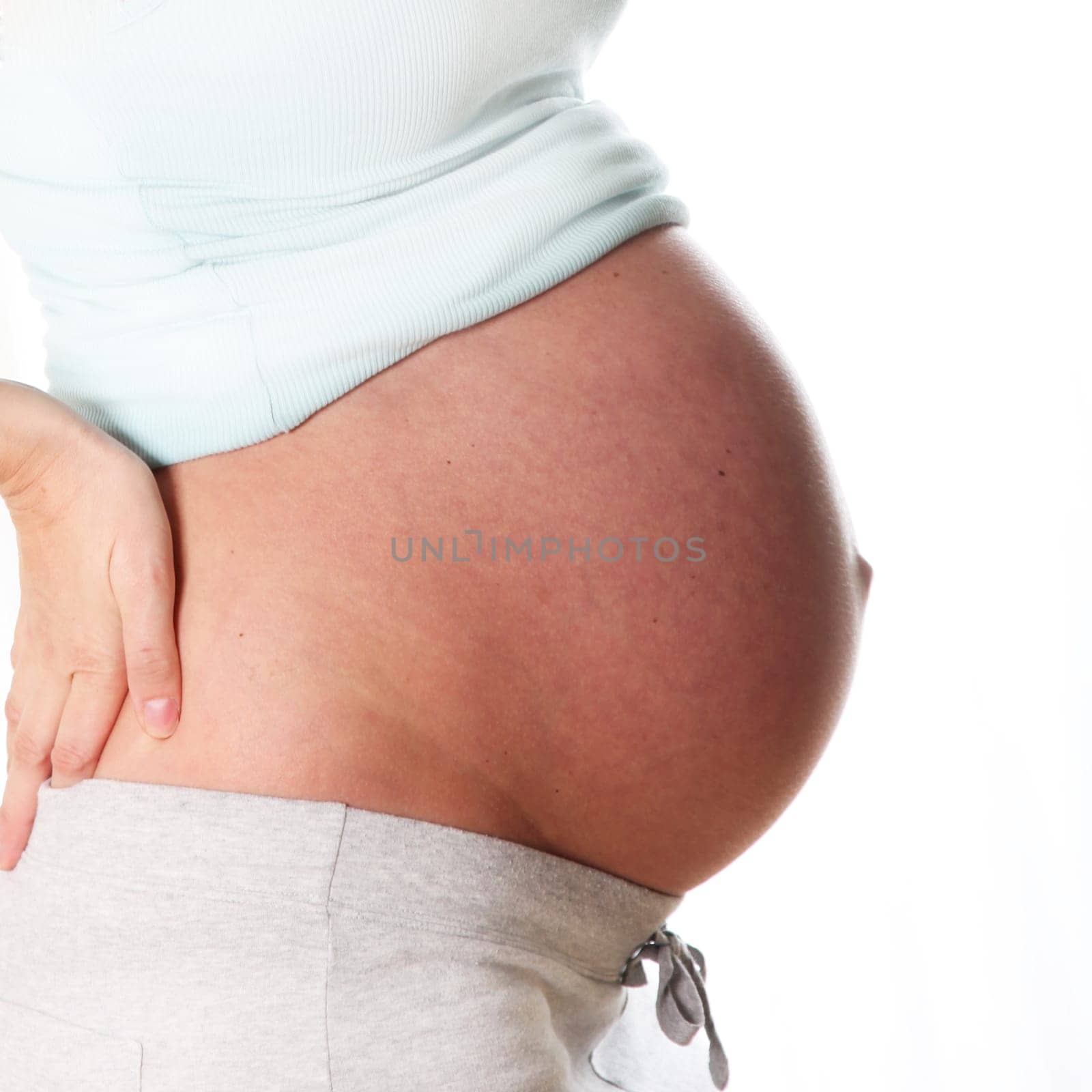 Baby bump in pregnancy. Only the belly can be seen from the side