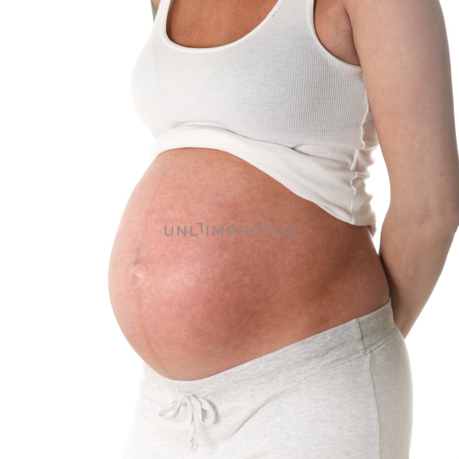 Pregnant woman only the belly is seen sideways - against a white background