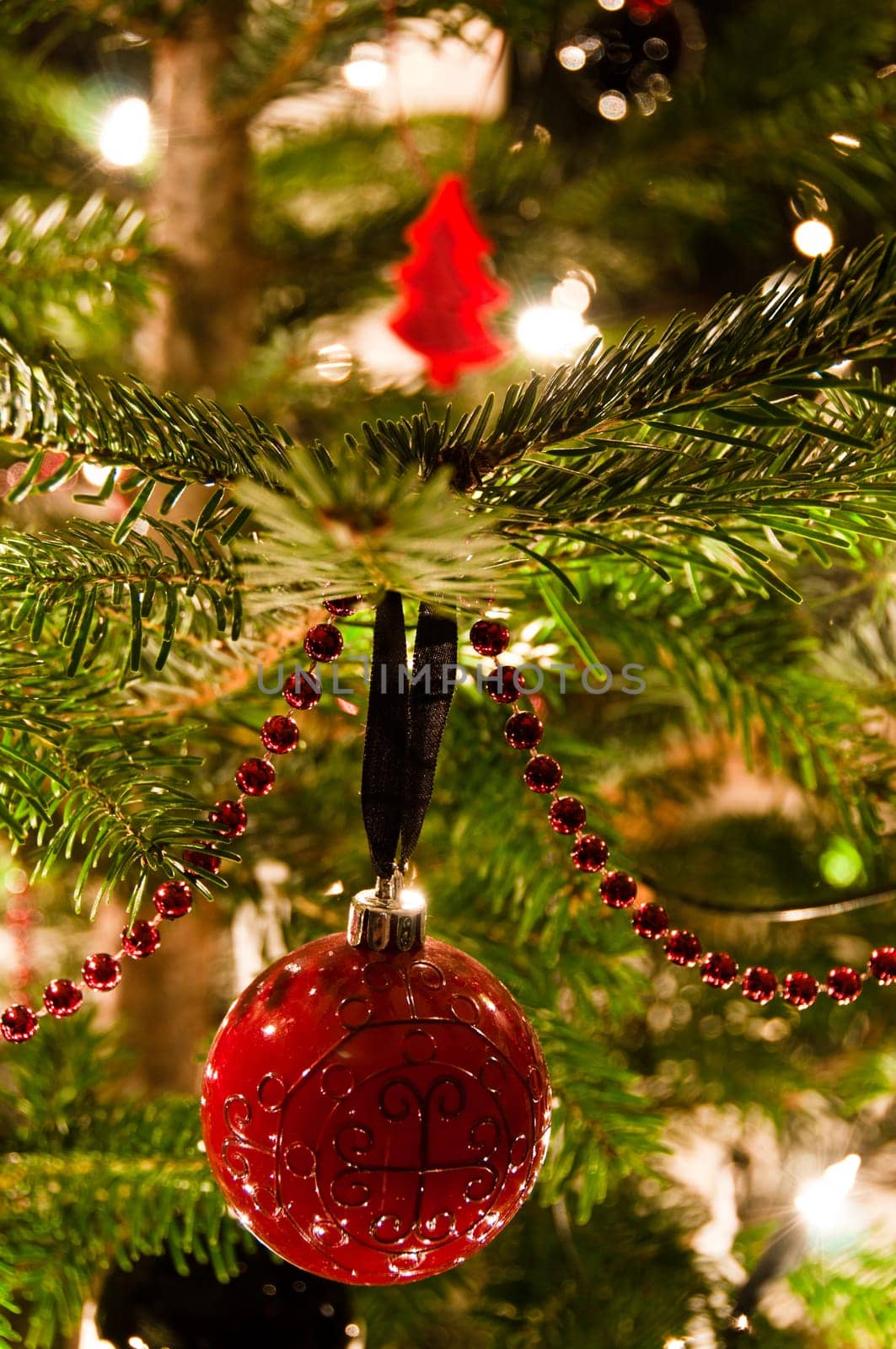 Various Christmas balls hanging from Christmas tee