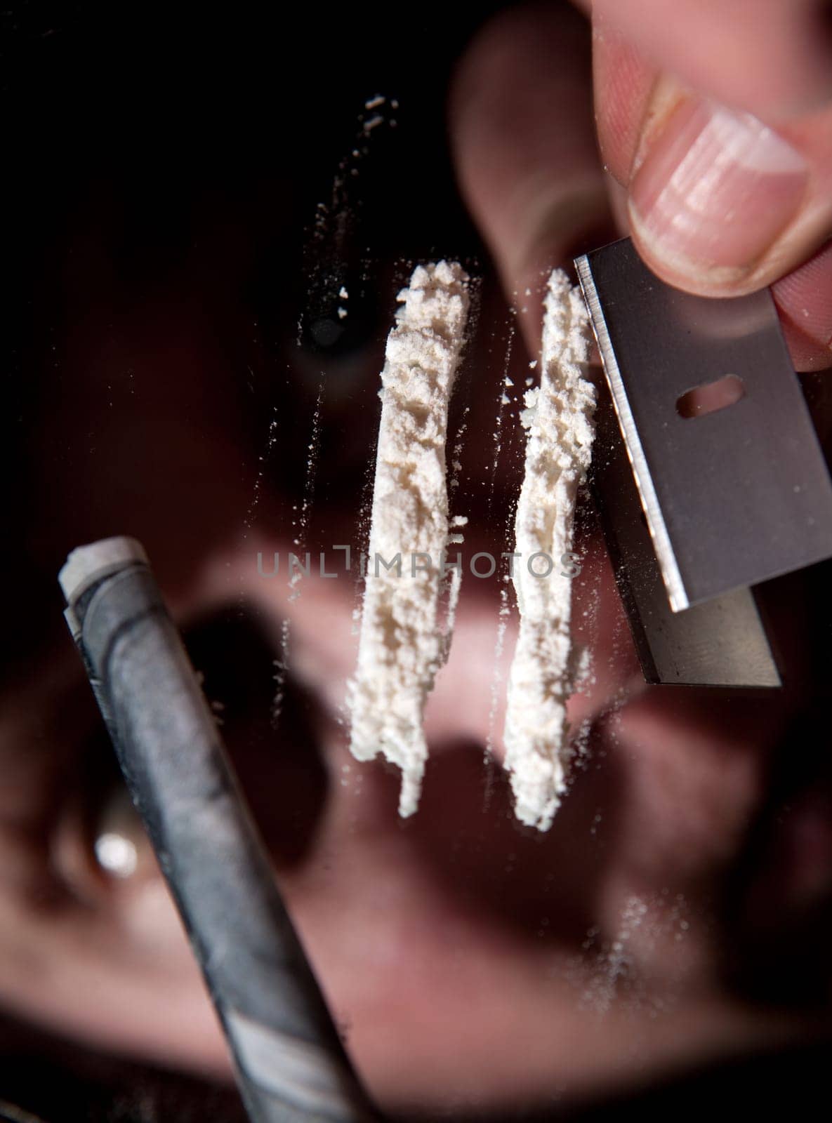 cocaine or other narcotic in line. addict with dollar bill for snorting illegal drugs