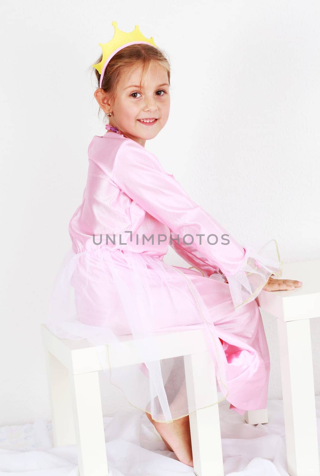 Adorable girl dressed as princess playing