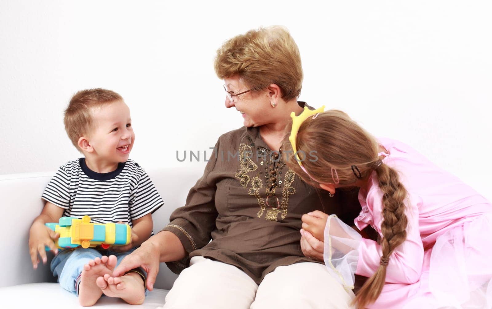 Cute little boy and little girl happy with grandmother
