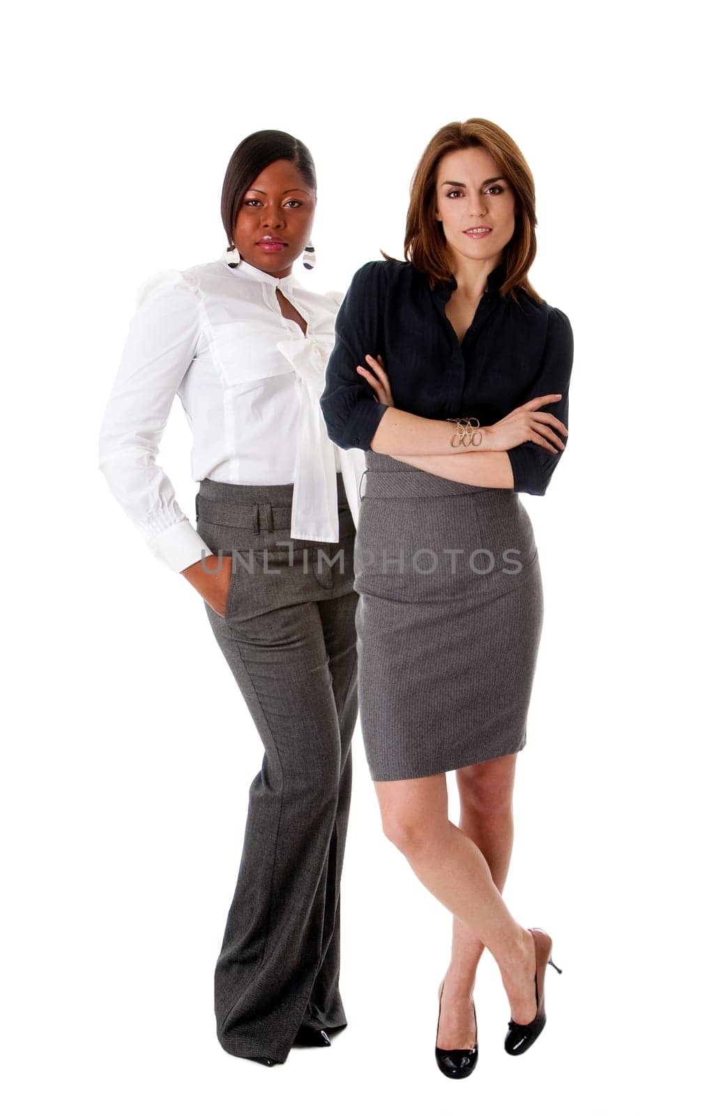 Beautiful Caucasian and African American business women standing next to each other as the dreamteam, isolated