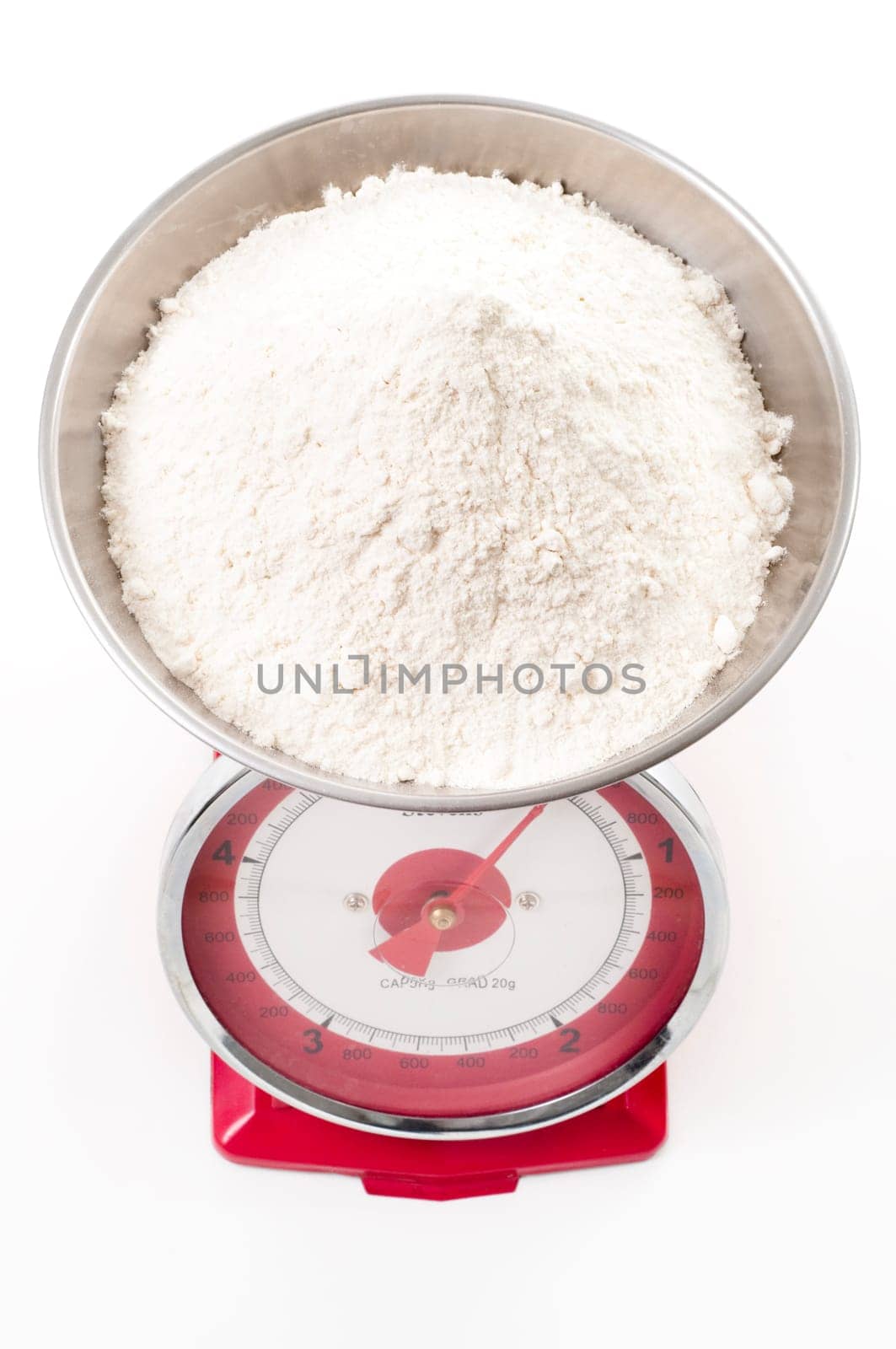 plain flour on red metal weighing scales
