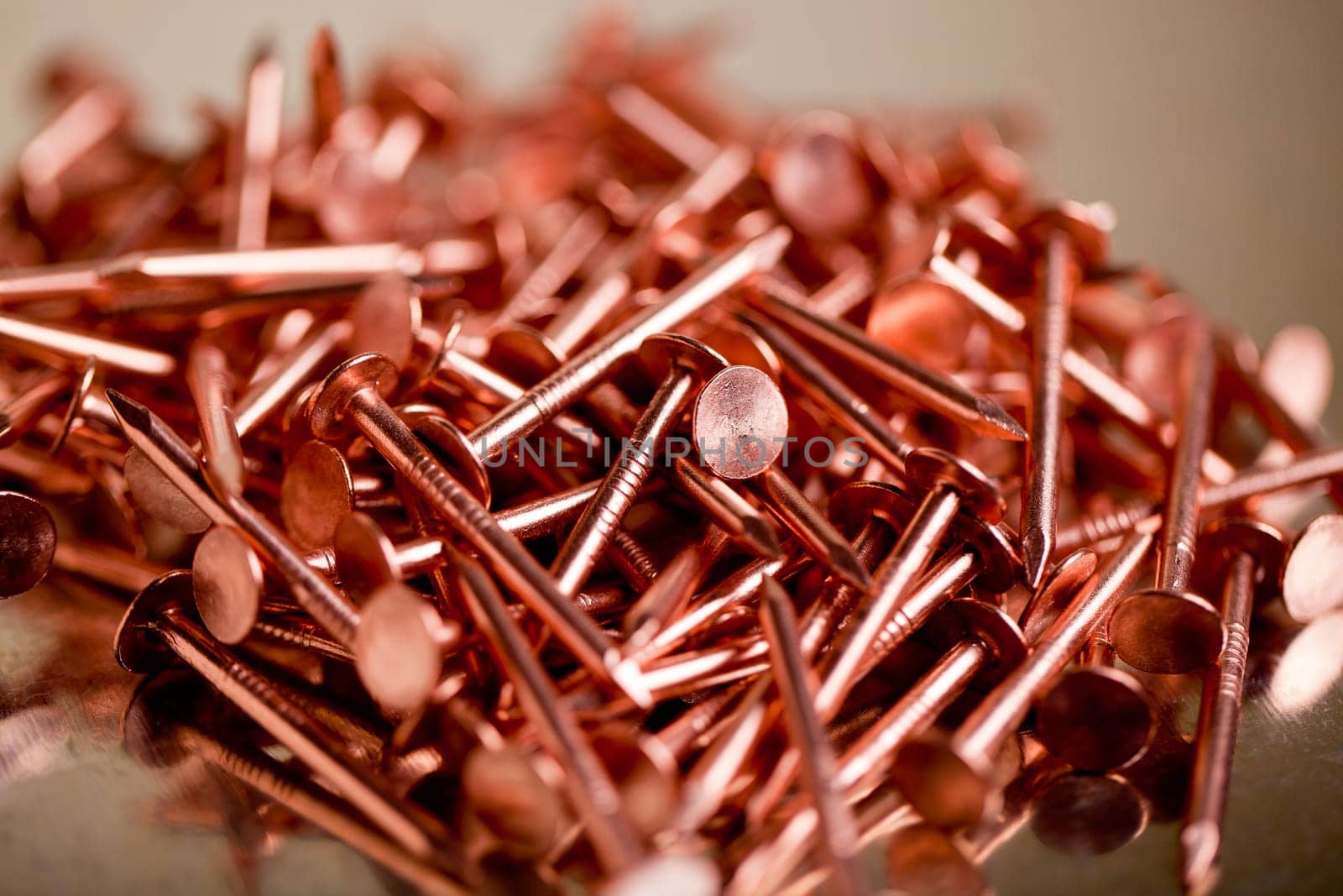 Copper Nails on Galvanized Steel Background With Shallow Focus