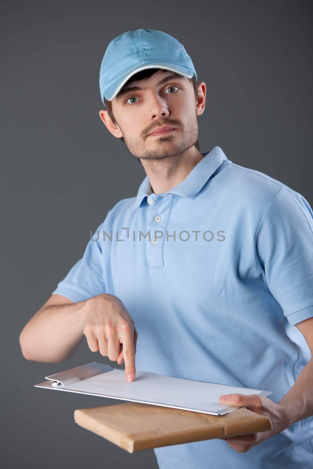 Courier man delivering a small package and requiring signature