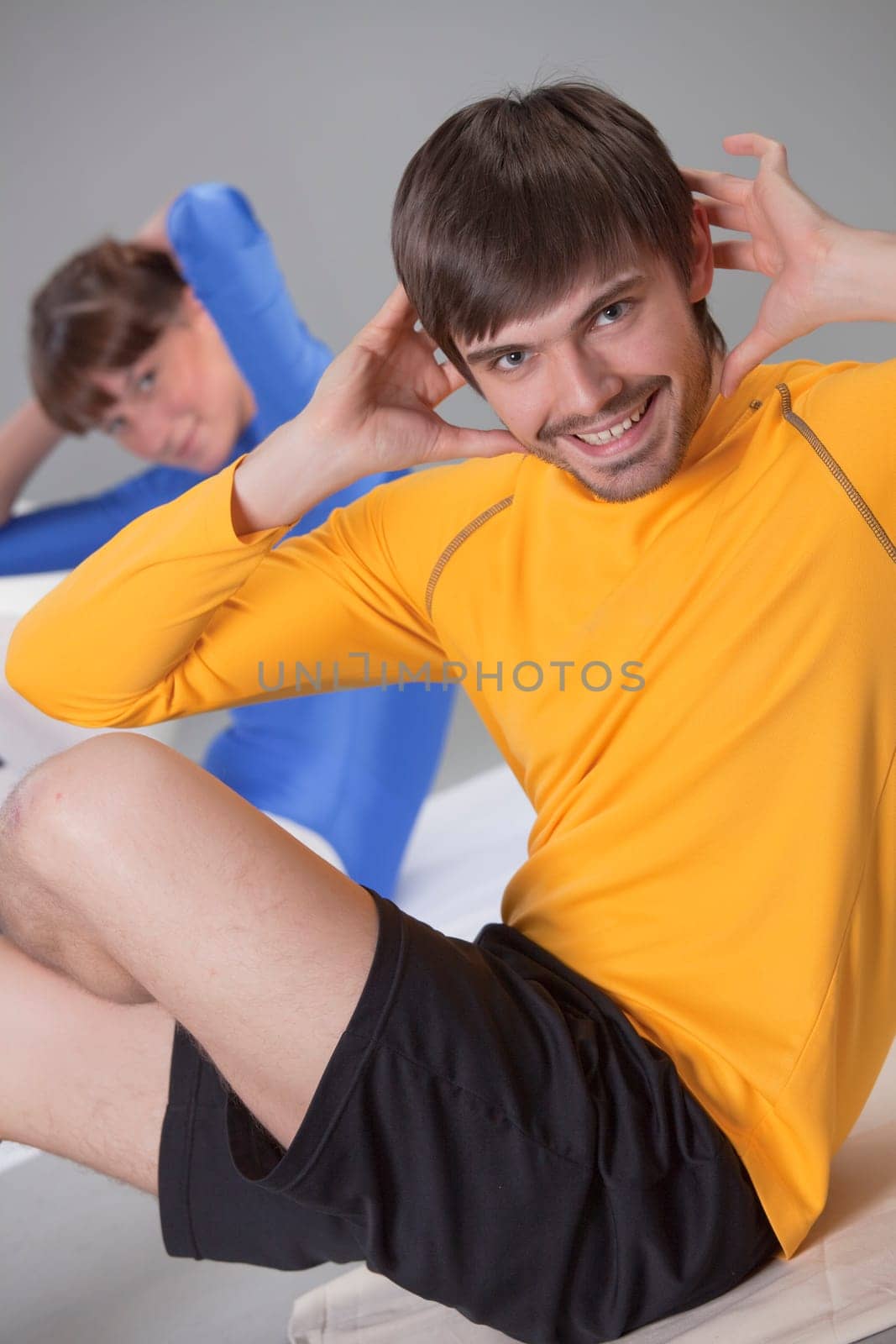 man and woman doing fitness exercises in studio