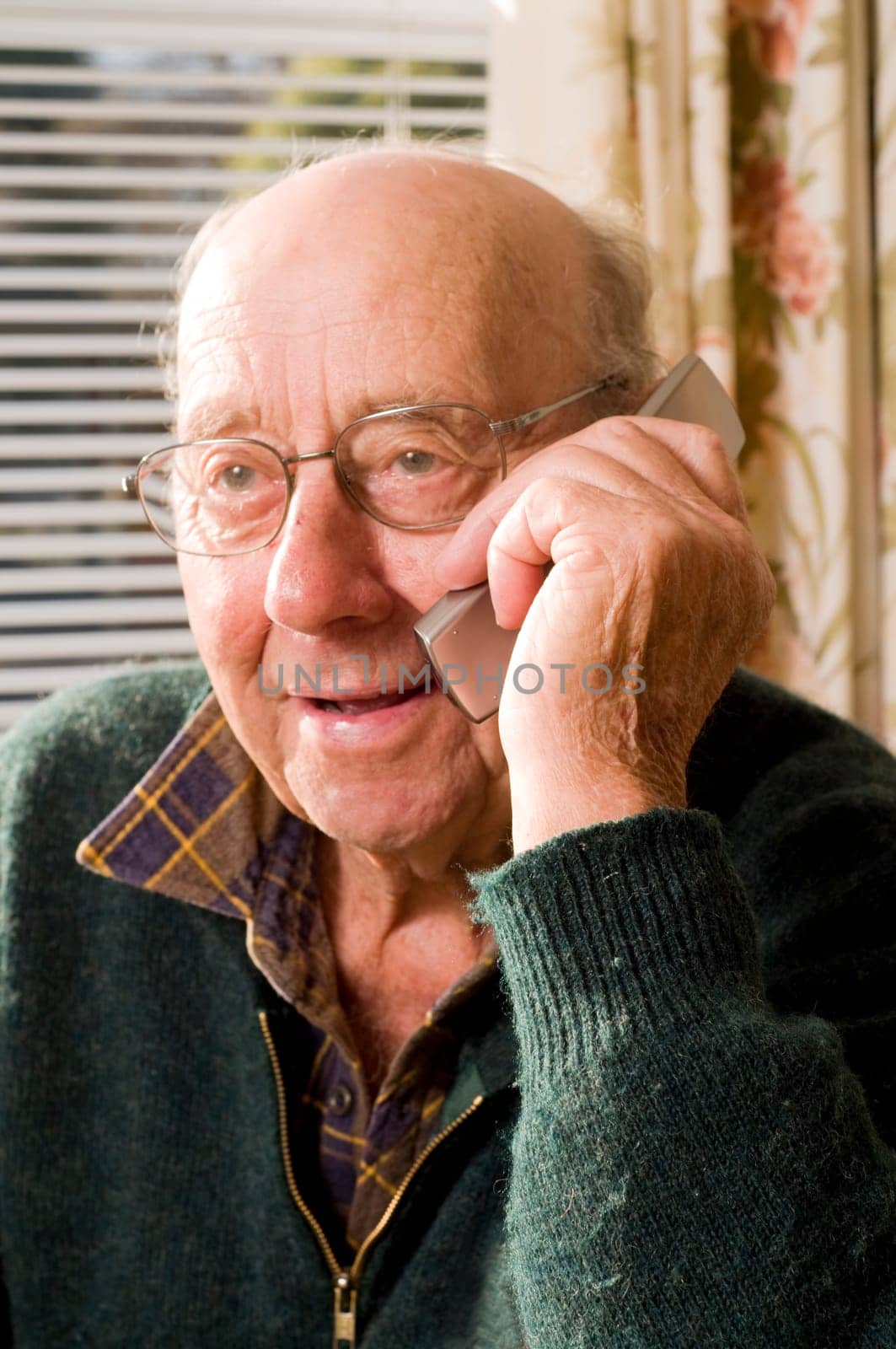 Senior man texting and calling with mobile phone