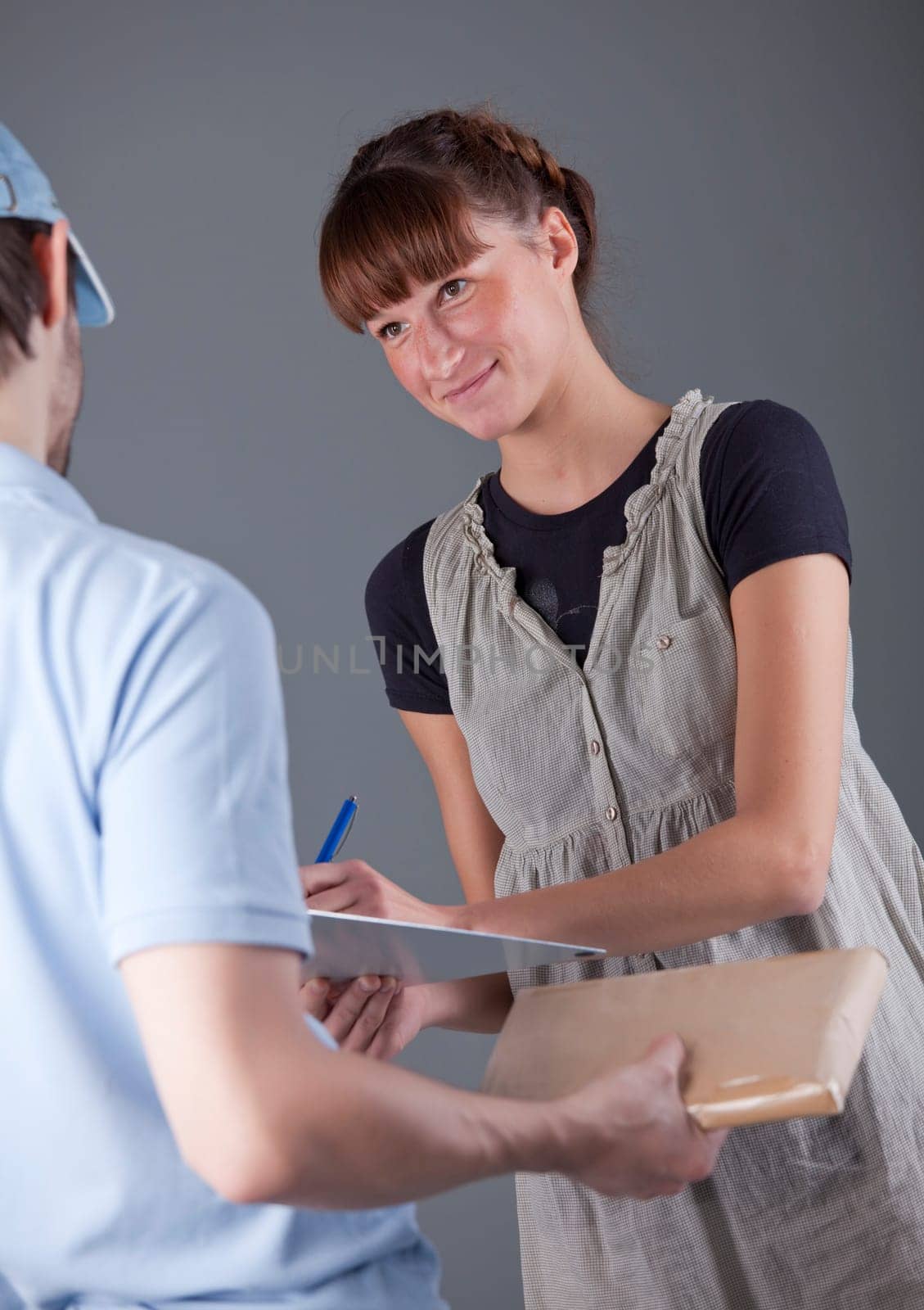 woman signs for delivering a small package