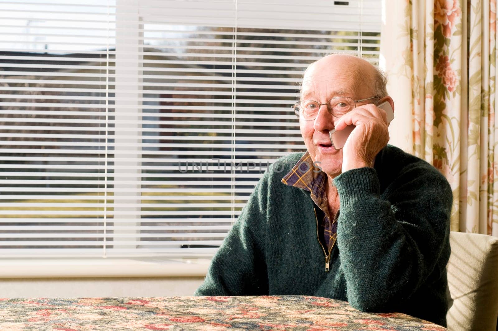 Senior man texting and calling with mobile phone