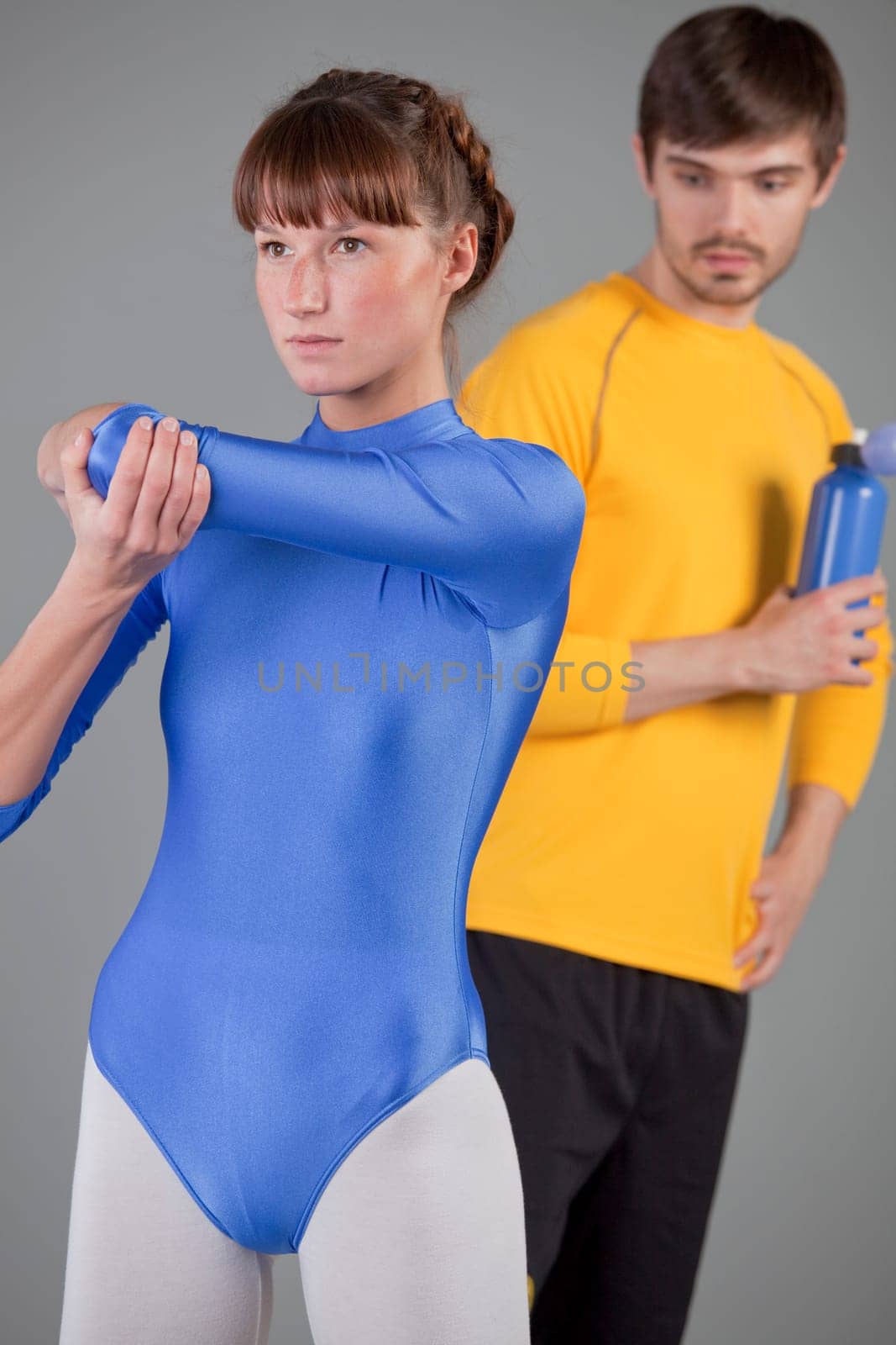 horny man in fitness studio looking at woman in blue leotard