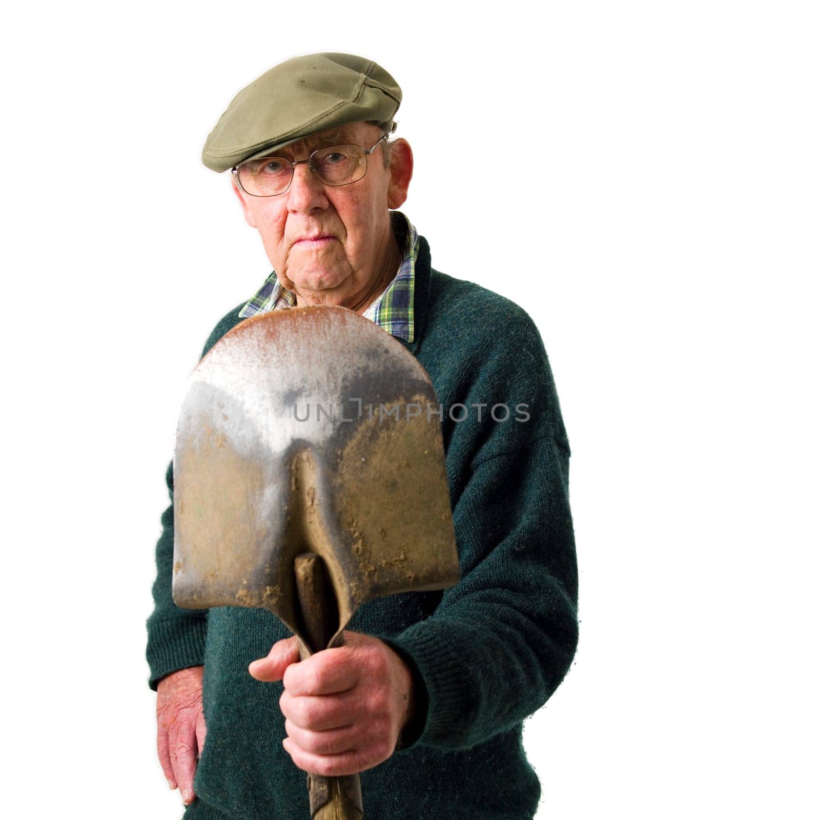 Senior man standing with shovel
