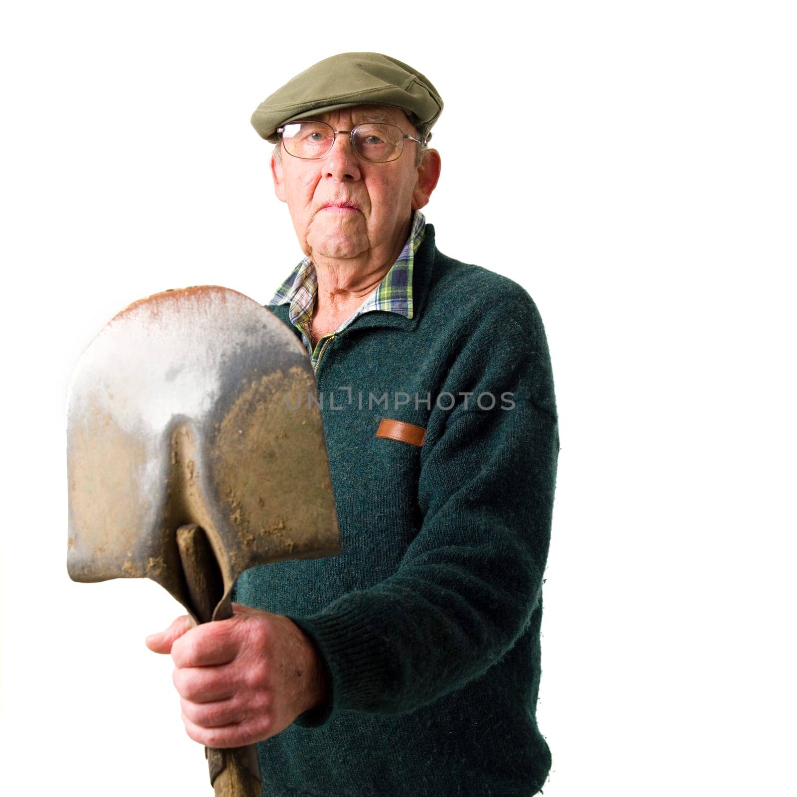 Senior man standing with shovel